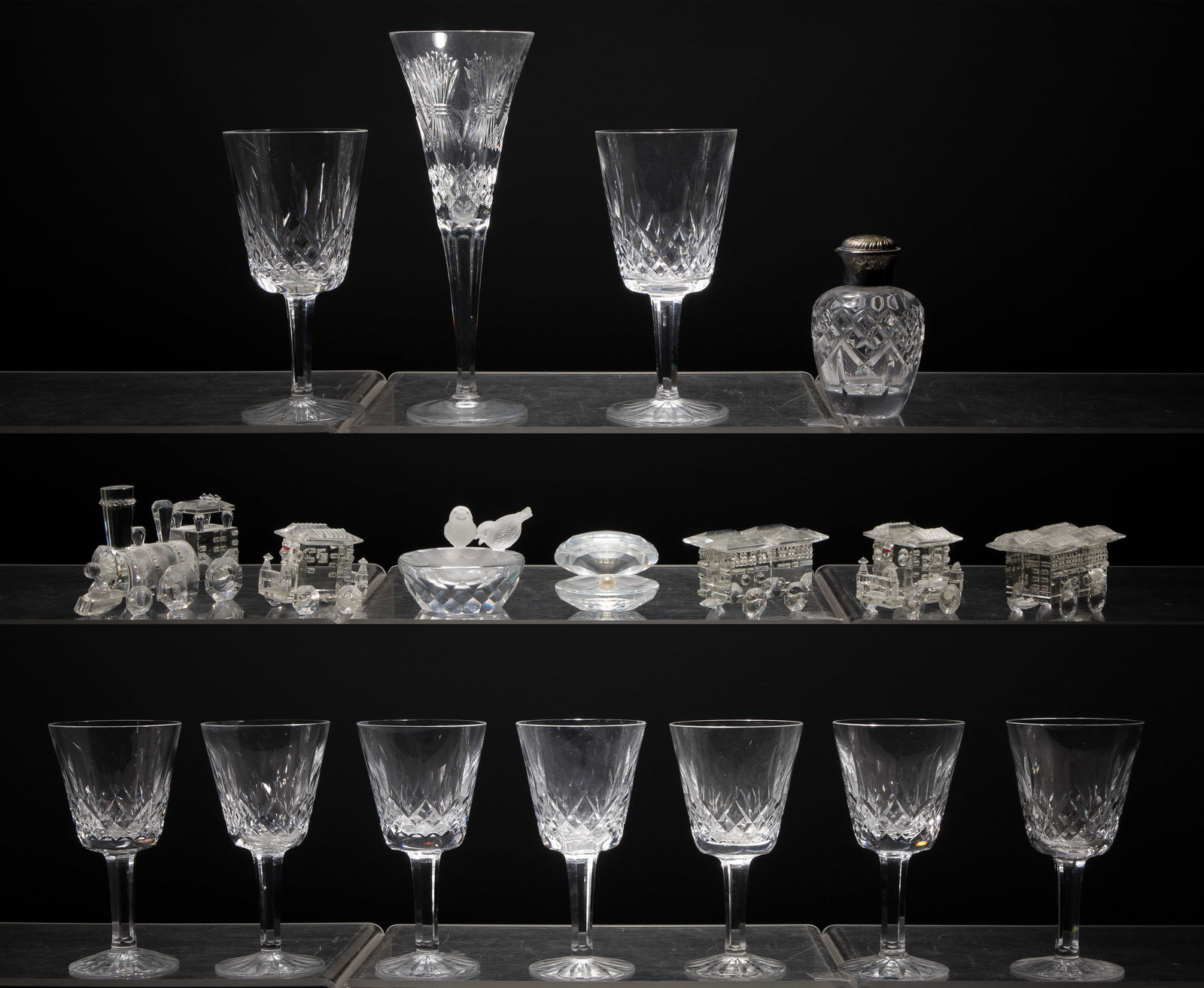 Crystal Assortment: Crystal Assortment (18) items including a set of (7) white wines, a pair of red wines and a perfume bottle all in the Lismore pattern and a toasting flute in the Millennial pattern, all marked on