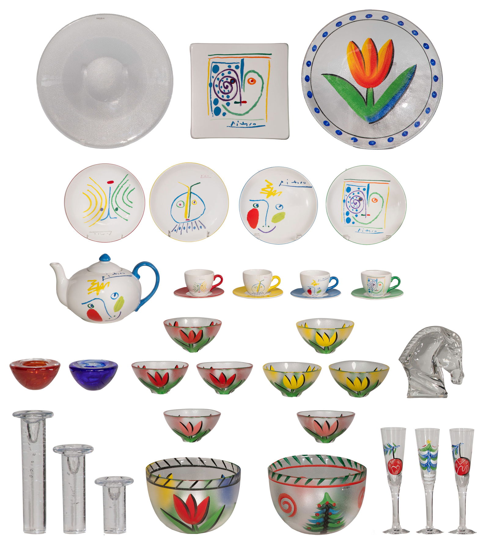 Kosta Boda Assortment: Kosta Boda Assortment (31) total items in various shapes, sizes, materials and colors including from collections Picasso, Tulipa and Christmas by Ulrica Hydman-Vallien, glass candleholders by