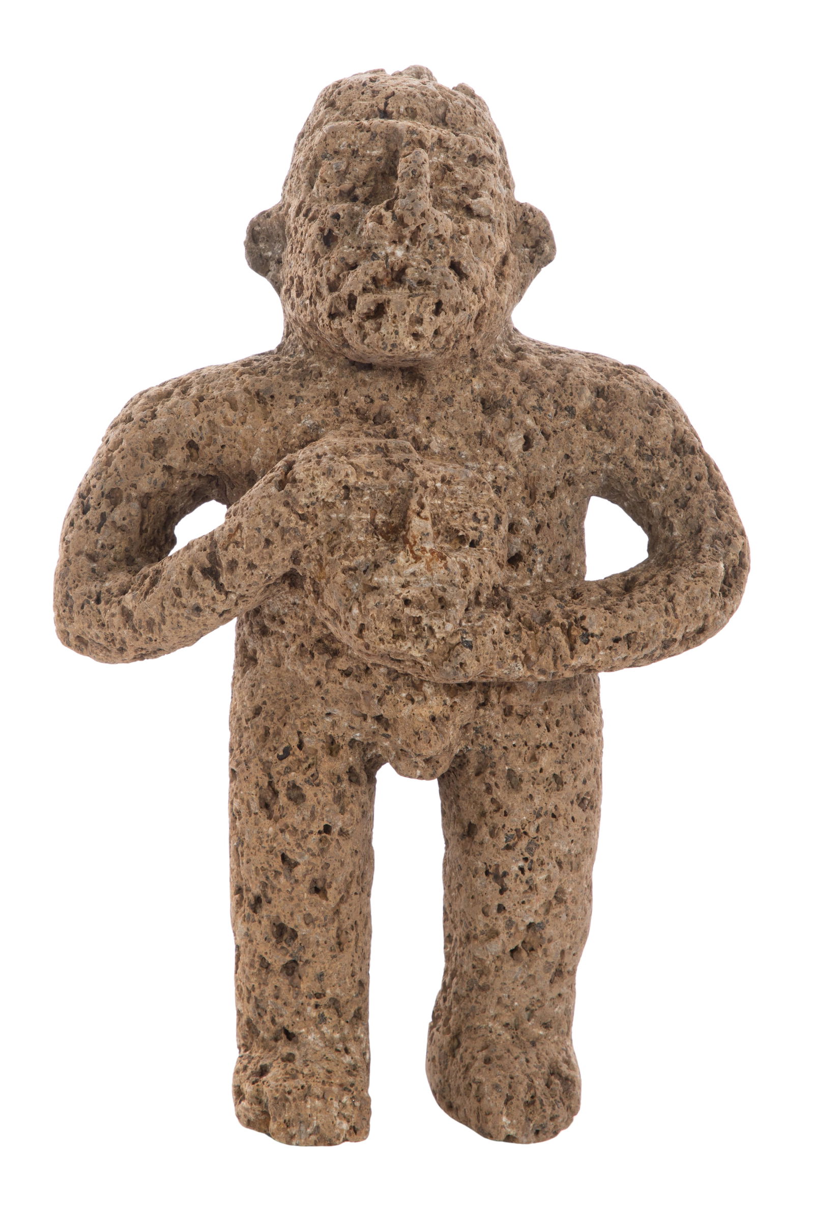 Pre-Columbian Headhunter Figure: Pre-Columbian Headhunter Figure Carved from porous gray volcanic stone, depicting a standing warrior holding a human head Property from: an Estate, Downers Grove, Illinois Height: 9 1/2 inches, Width: