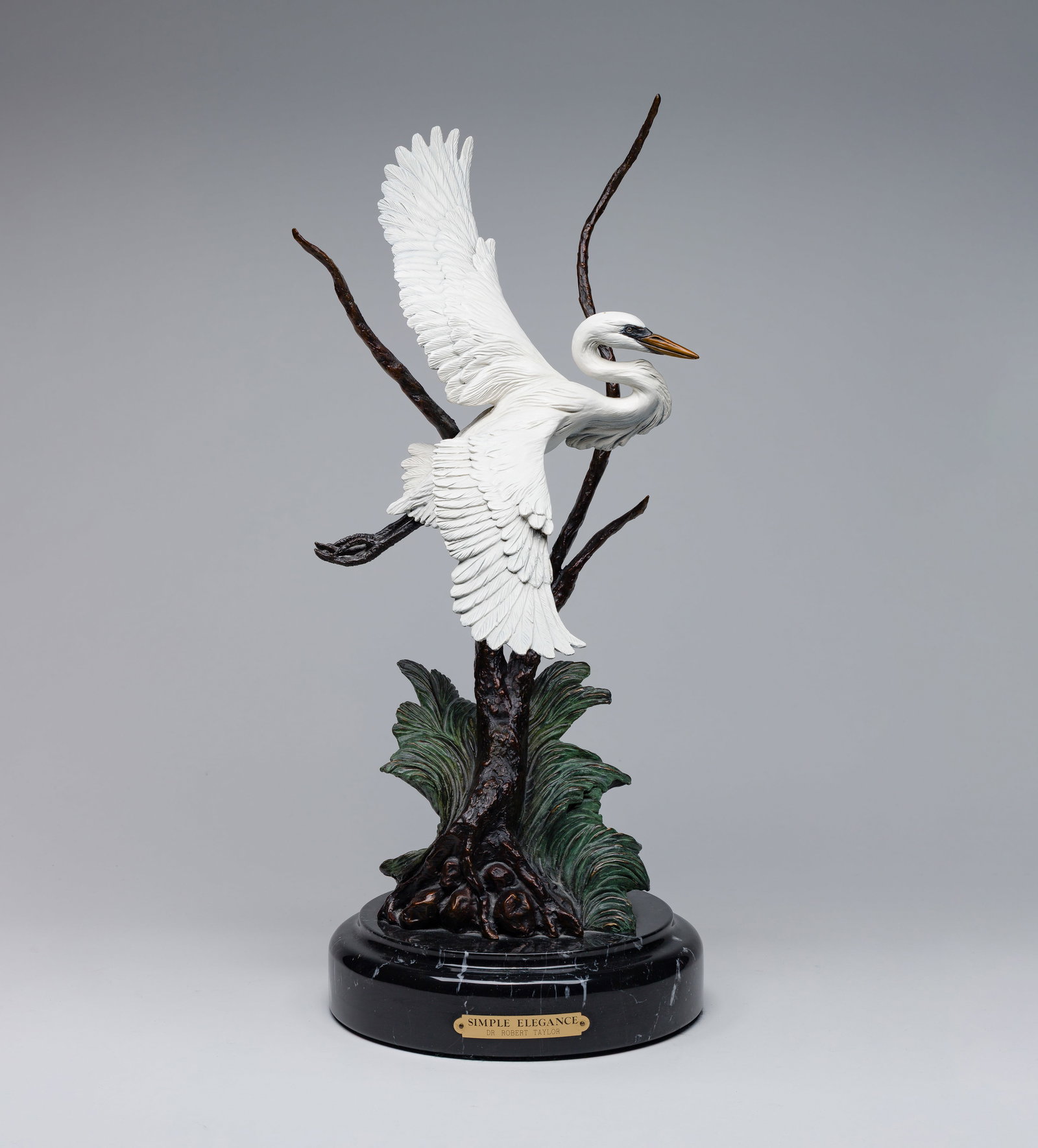 Dr. Robert Taylor (American, 20th Century) 'Simple Elegance' Bronze Heron Sculpture: Dr. Robert Taylor (American, 20th Century) 'Simple Elegance' Bronze Heron Sculpture 1998, signed, #12/50, cold painted bronze depicting a heron in flight, set on a hard stone base Property