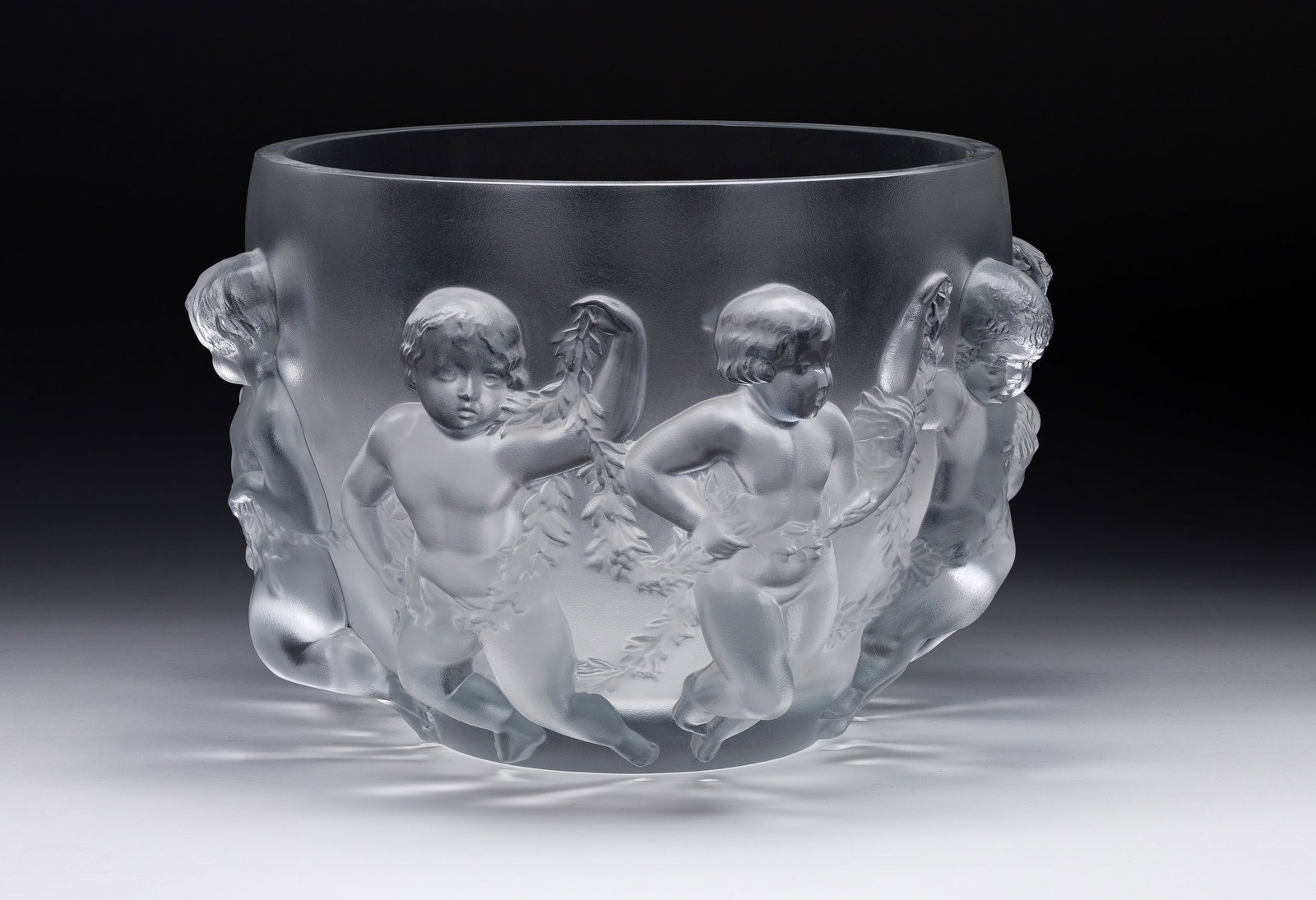 Lalique Crystal Luxembourg Centerpiece Bowl: Lalique Crystal Luxembourg Centerpiece Bowl Having a continual band of putti dancing in high relief, marked on underside Property from: a Private Collector, Evanston, Illinois Height: 8 3/8