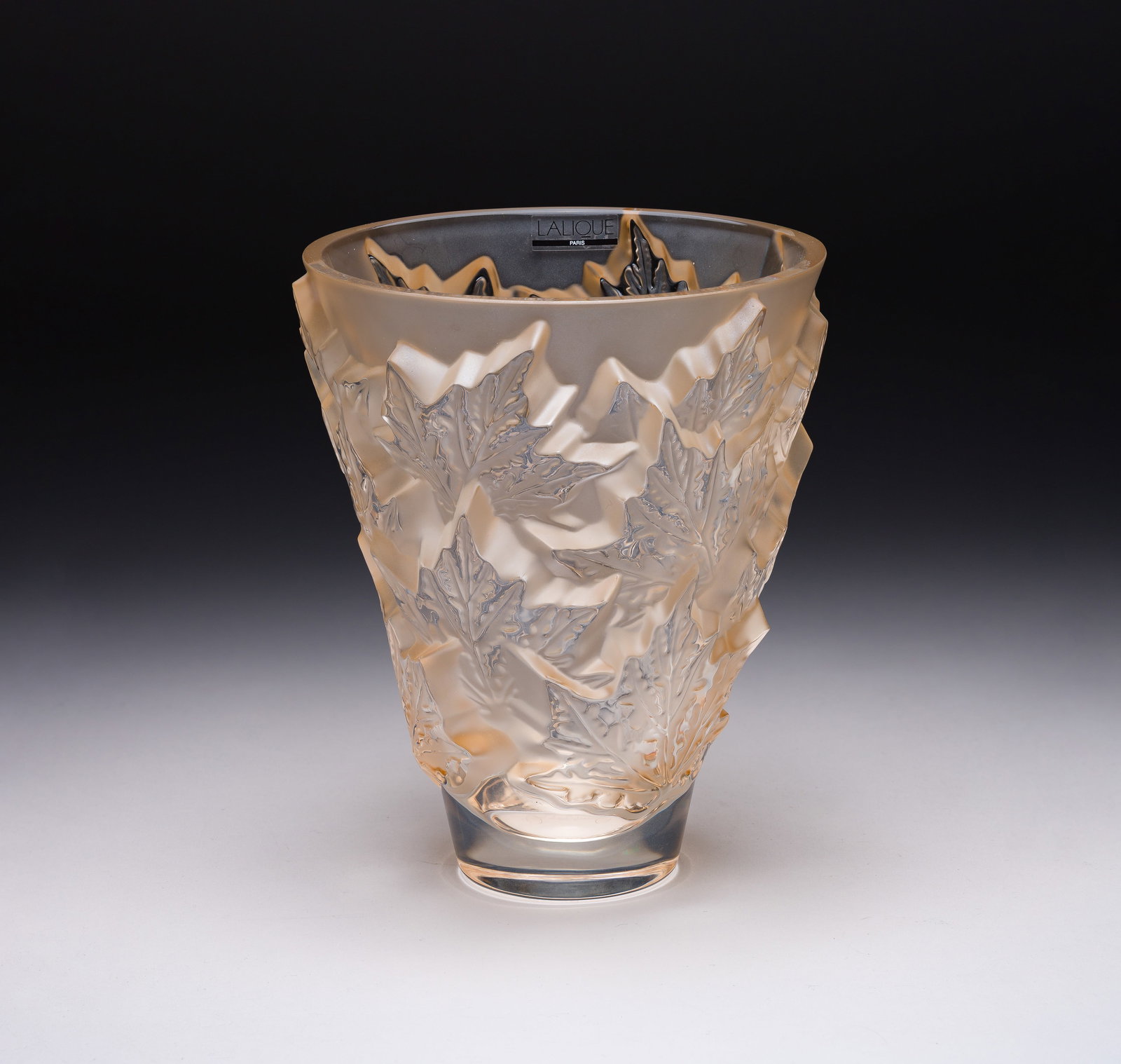 Lalique Crystal Champs-Elysees Vase: Lalique Crystal Champs-Elysees Vase A gold-luster color having leaves, marked on underside and retaining original label Property from: an Estate, Madison, Wisconsin Height: 7 inches,