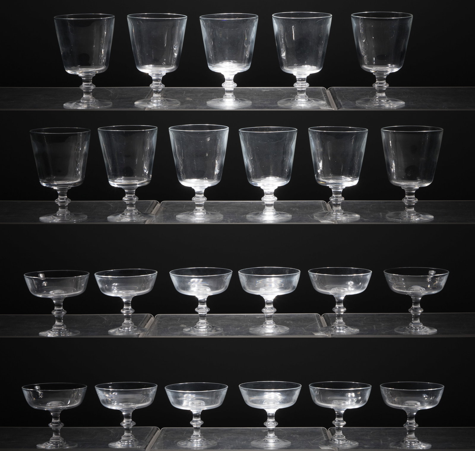 Steuben Crystal Stemware: Steuben Crystal Stemware (23) items including a set of (12) 7846 champagne coups and (11) 7725 water goblets, all marked, in original storage boxes and dust bags marked 'Marshall Fields and Co.