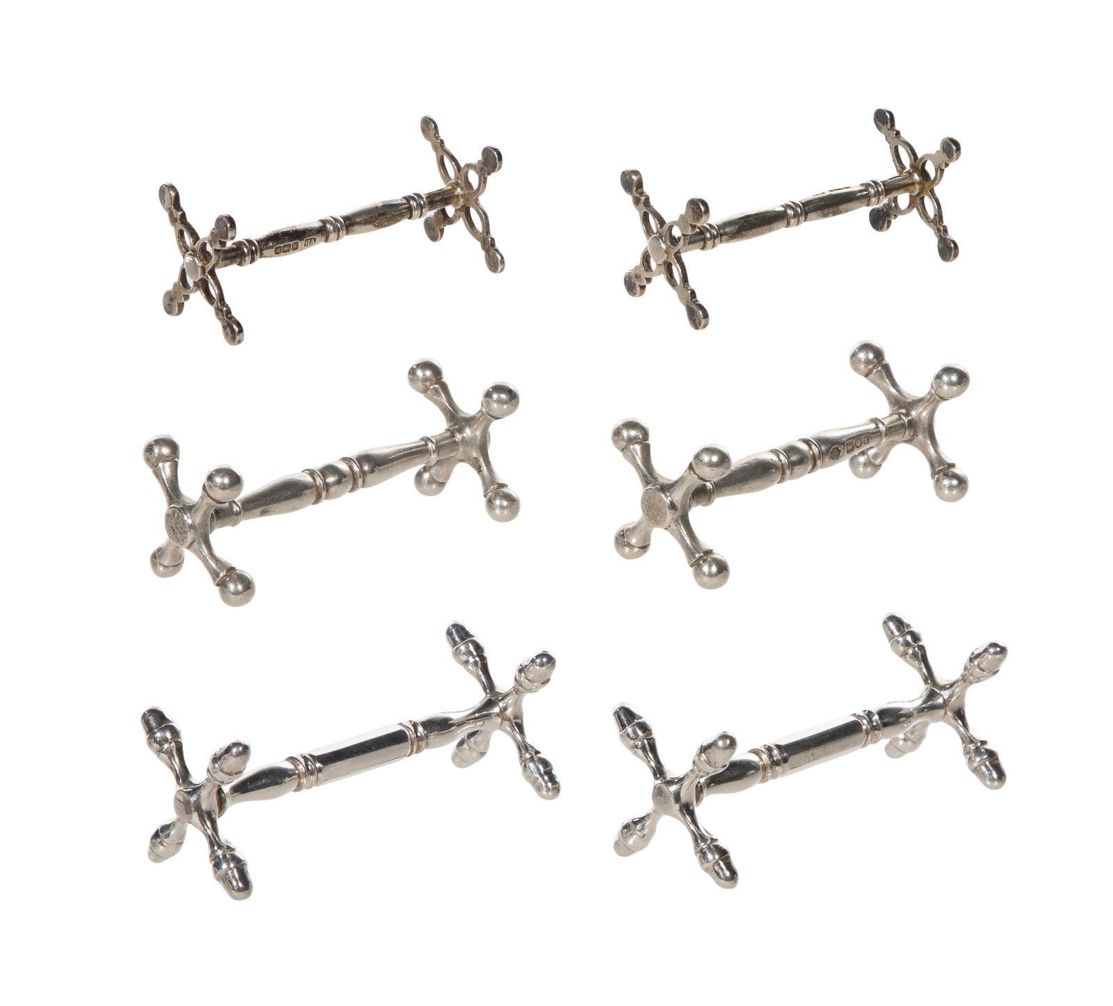 Silver Knife Rest Assortment: Silver Knife Rest Assortment (6) items, all having a crossed-end sawbuck design including a set of (2) open work (hallmarked Harry Atkin / lion passant), a set of (2) ball end (hallmarked William