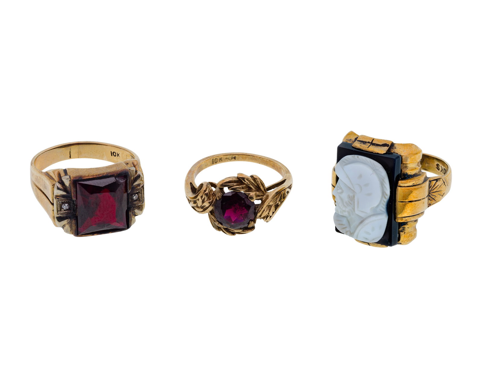 10k and 9k Yellow Gold and Gemstone Ring Assortment: 10k and 9k Yellow Gold and Gemstone Ring Assortment (3) items including a carved onyx (marked '10k') and (2) garnet (unmarked 9k) Property from: a Private Collector, Elmhurst, Illinois Size: 7 (garnet