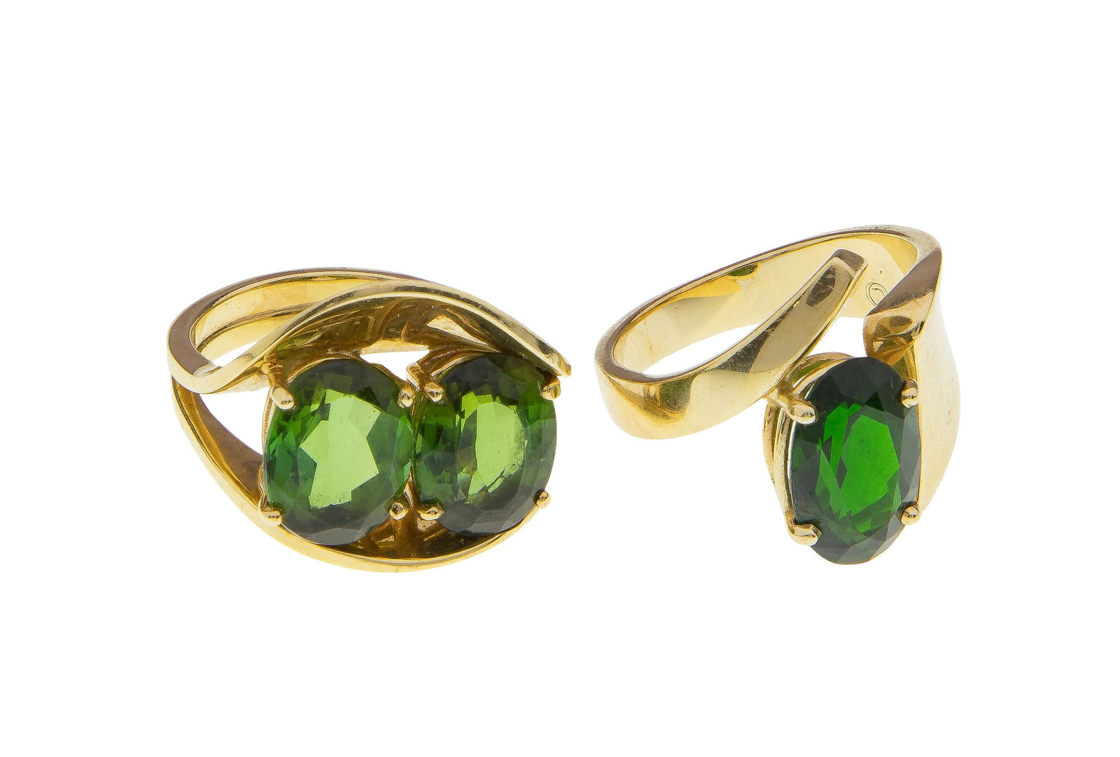 14k Yellow Gold and Emerald Rings: 14k Yellow Gold and Emerald Rings (2) items including a cocktail ring having two oval cut emeralds in a free form setting and an oval cut emerald in a crossover setting (both marked '14k') 