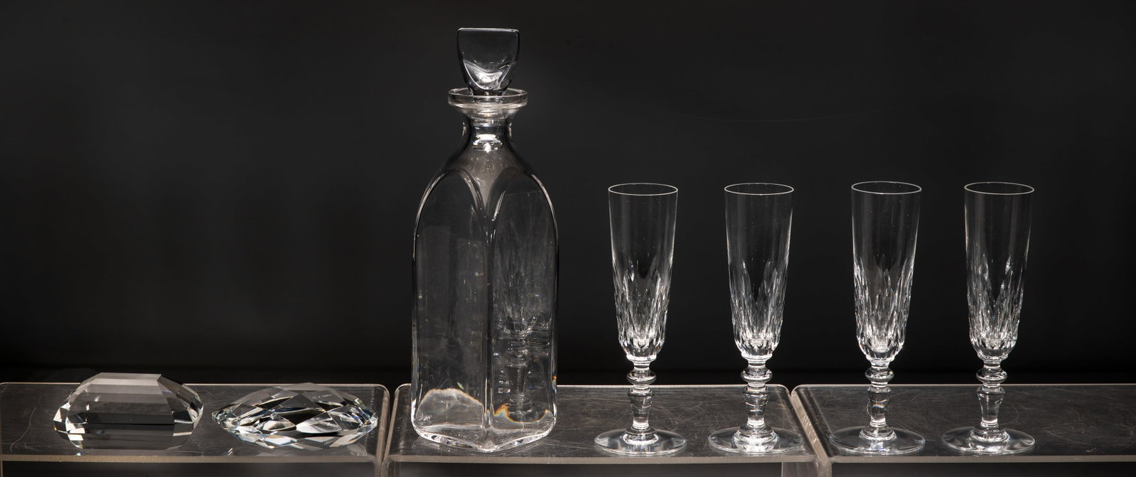 Tiffany Crystal Assortment: Tiffany Crystal Assortment (7) items including a set of (4) champagne flutes in a Tiffany & Co. fitted box, (2) jewel style paperweights having original pouches and a decanter in an original gift box,