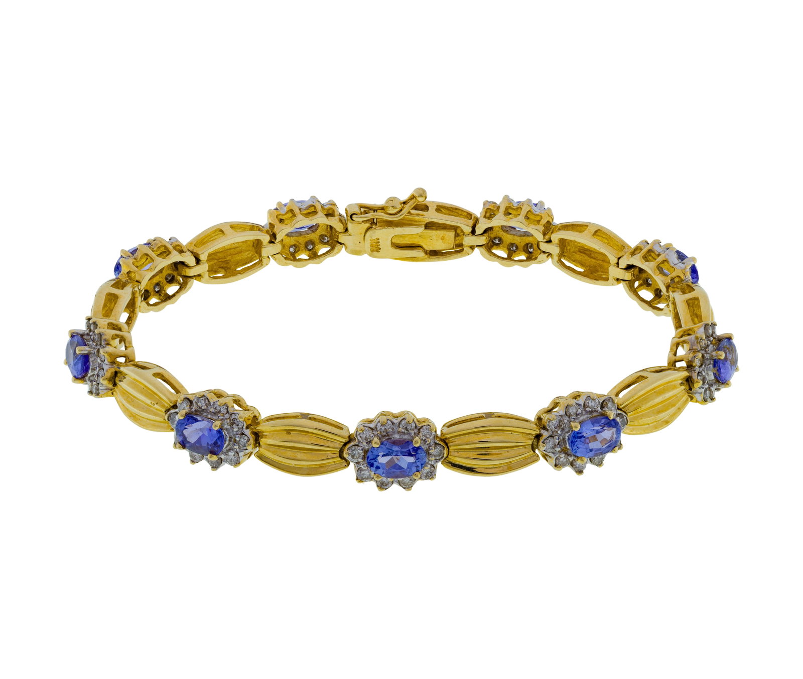 14k Yellow Gold, Tanzanite and Diamond Bracelet: 14k Yellow Gold, Tanzanite and Diamond Bracelet A link style having 0.375-inch wide alternating links of oval cut tanzanite encircled by diamond accents and ribbed gold (marked '14k') Property from: a