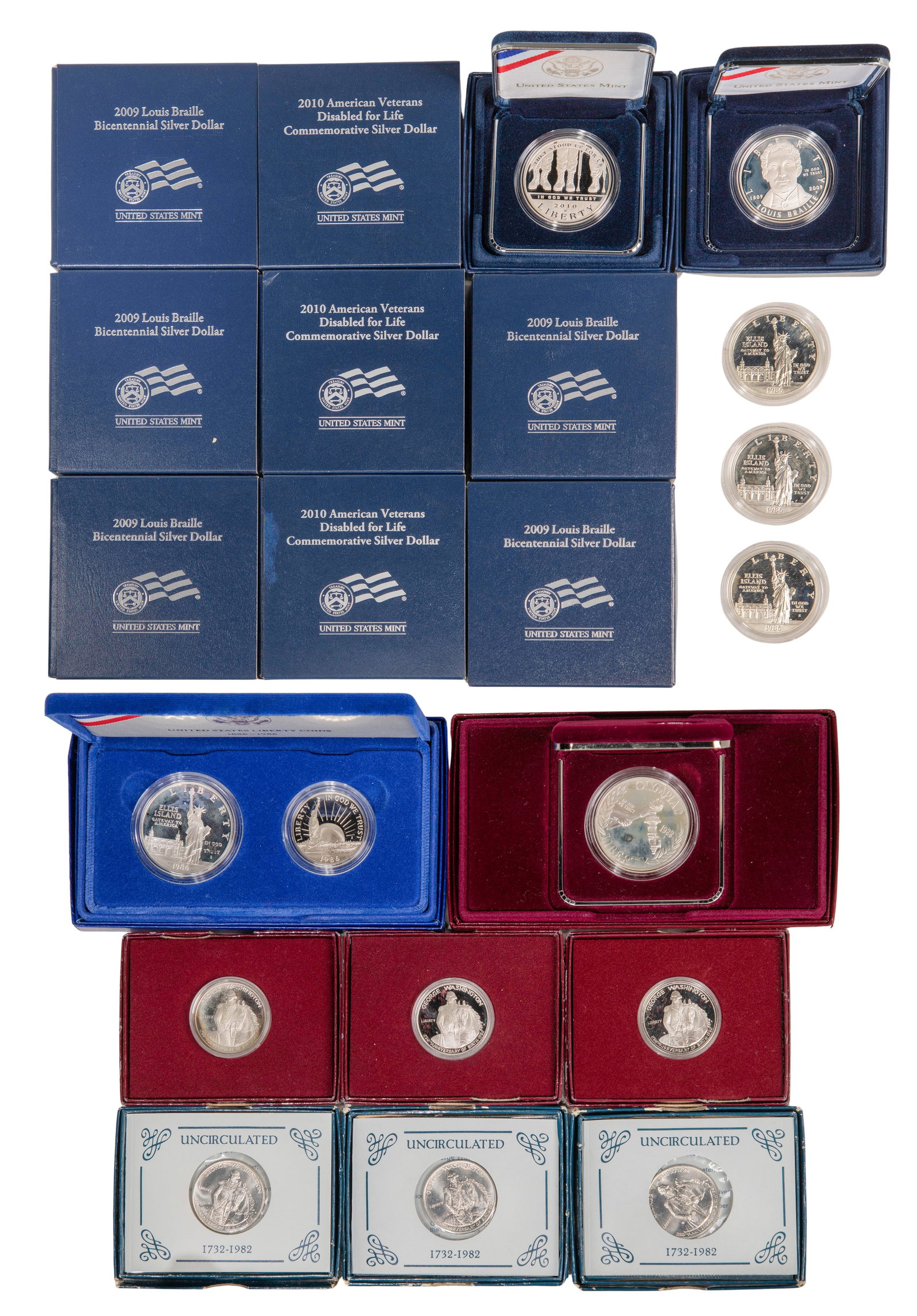 Silver Commemorative Assortment: Silver Commemorative Assortment (21) items including (6) 1732-1982 George Washington Commemorative 50c, a 1886-1986 Liberty Coin Set having 50c and $1, a 1988 Olympic $1, (3) 1986 Ellis Island $1, (6)