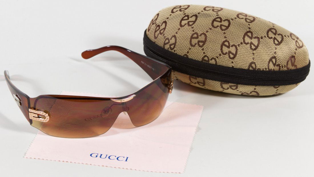 Gucci Sunglasses: Gucci Sunglasses Includes brown glasses with case Height: 3.00 inches, Width: 7.00 inches, Depth: 3.50 inches (case) Category: Clothing & Accessories > Other Shipping Status: Leonard Auction, Inc. wil