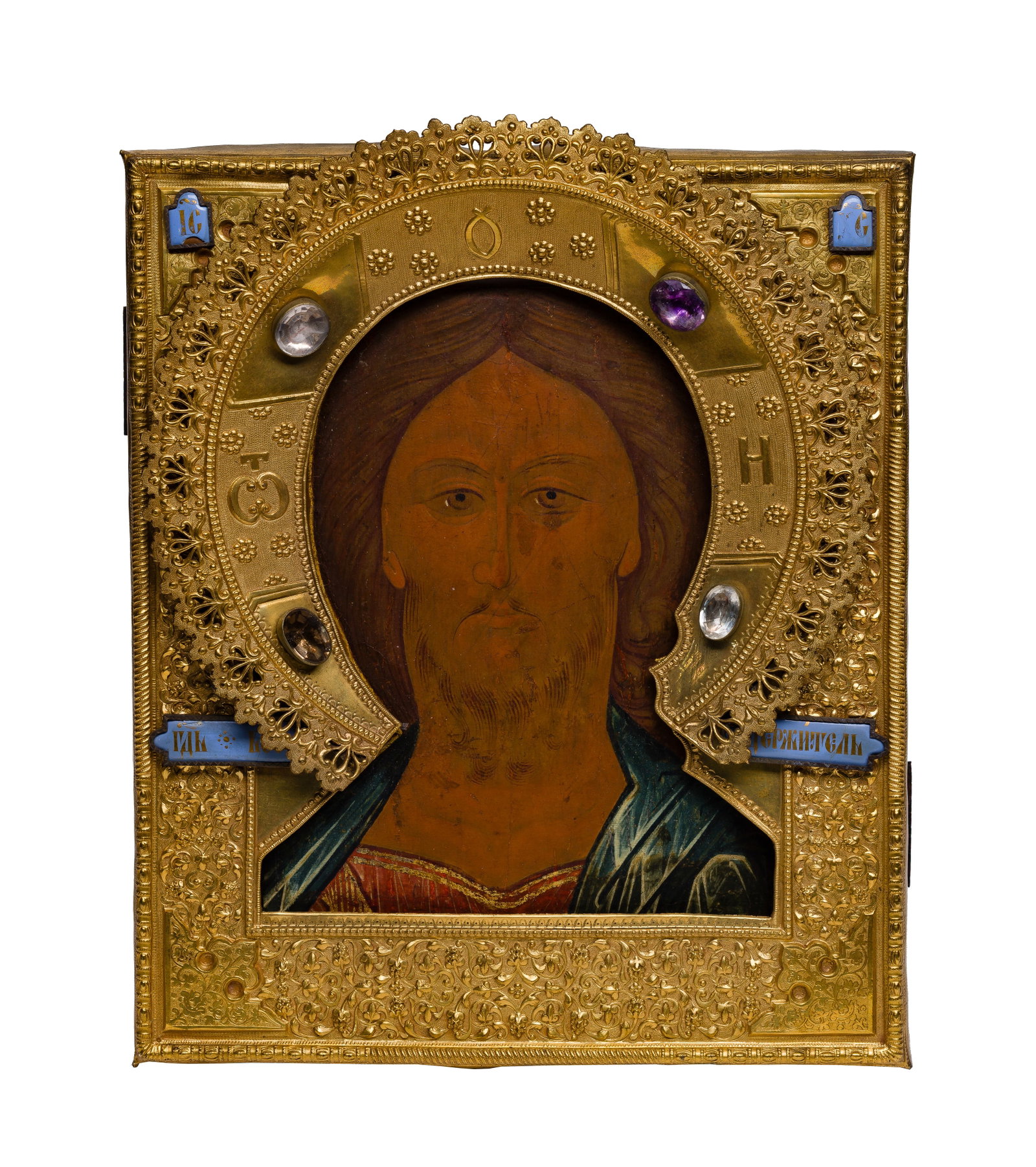 19th Century Russian Icon: 19th Century Russian Icon Tempera on wood panel and an elaborate repousse and chased brass oklad having four attached blue enamels having gilt Cyrillic, an open work halo having topazes, an 1897