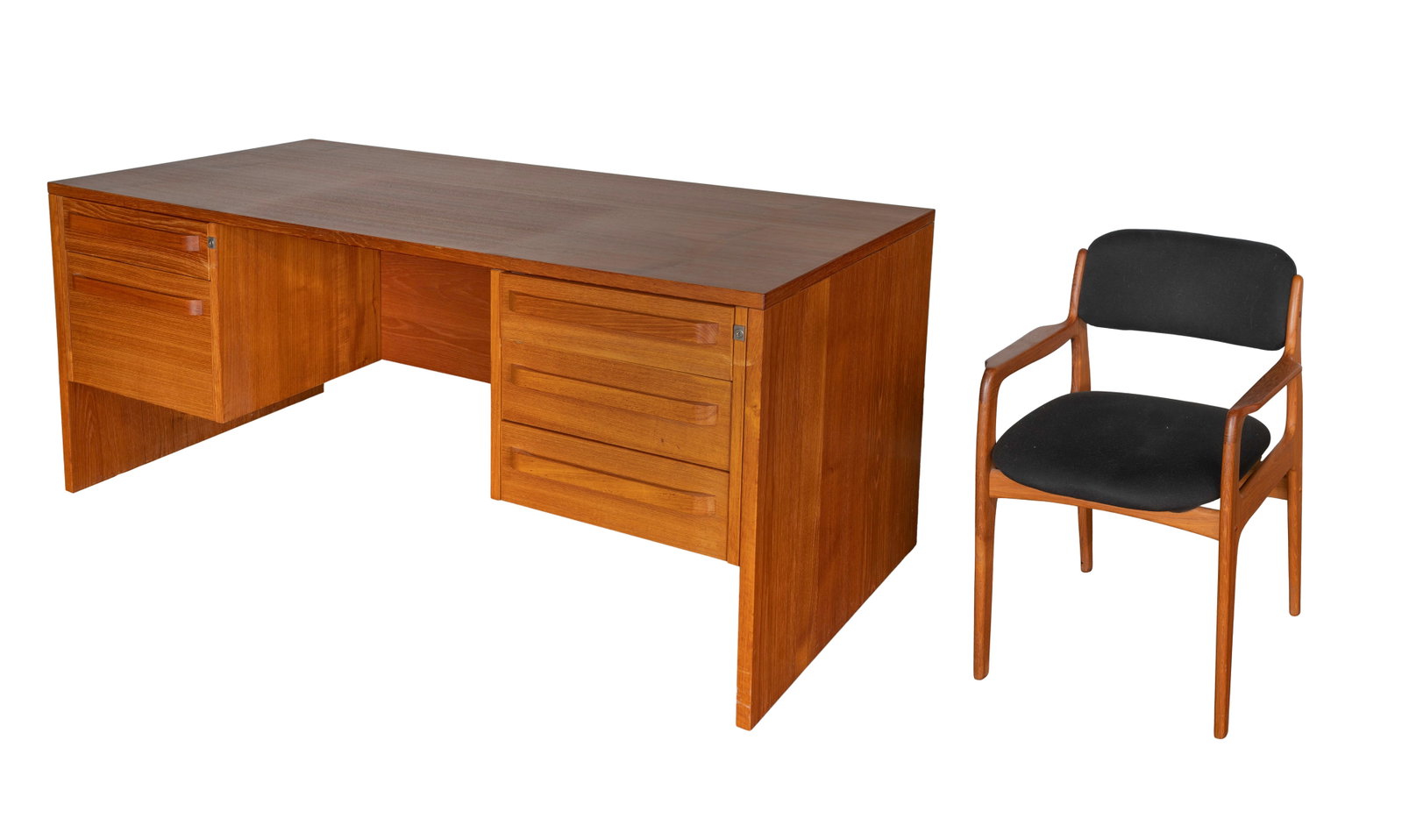 Modern Teak Desk and Armchair: Modern Teak Desk and Armchair An unmarked desk having three drawers to the right and a drawer over a deep file drawer to the left of knee-hole, both sides locking (four keys present) and an