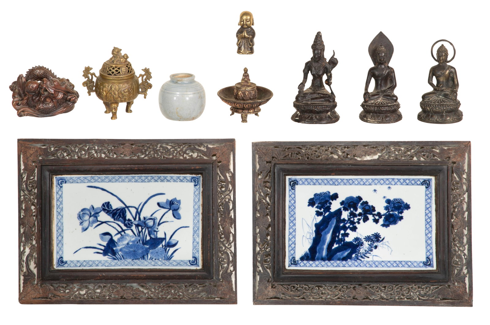Asian Decorative Object Assortment: Asian Decorative Object Assortment (10) items including (2) underglaze blue porcelain plaques in open-work carved wood frames, a celadon porcelain jar, (3) copper alloy seated Buddhas, a miniature