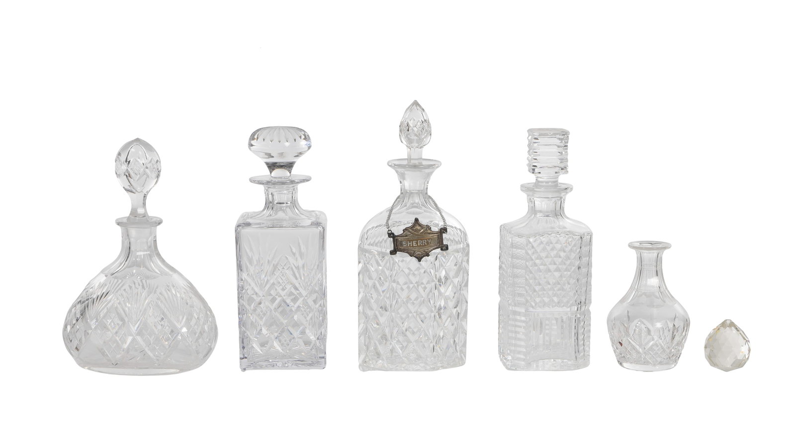 Crystal Assortment: Crystal Assortment (6) items including a Waterford decanter having etched mark, an unmarked sherry decanter having silverplate tag on chain, (2) unmarked decanters, a vase and a pendant Property