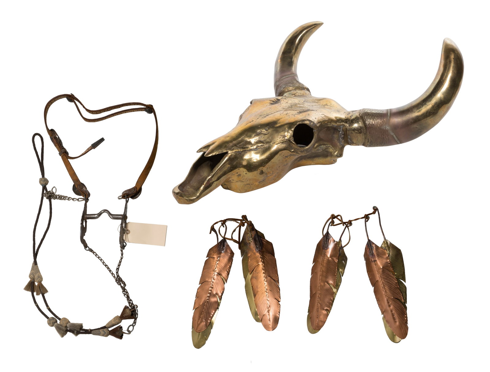 Brass Steer Skull Wall Mount: Brass Steer Skull Wall Mount (2) total items including the polished cast brass skull having copper and brass feather shaped attachments suspended from the horns on leather straps; together with a