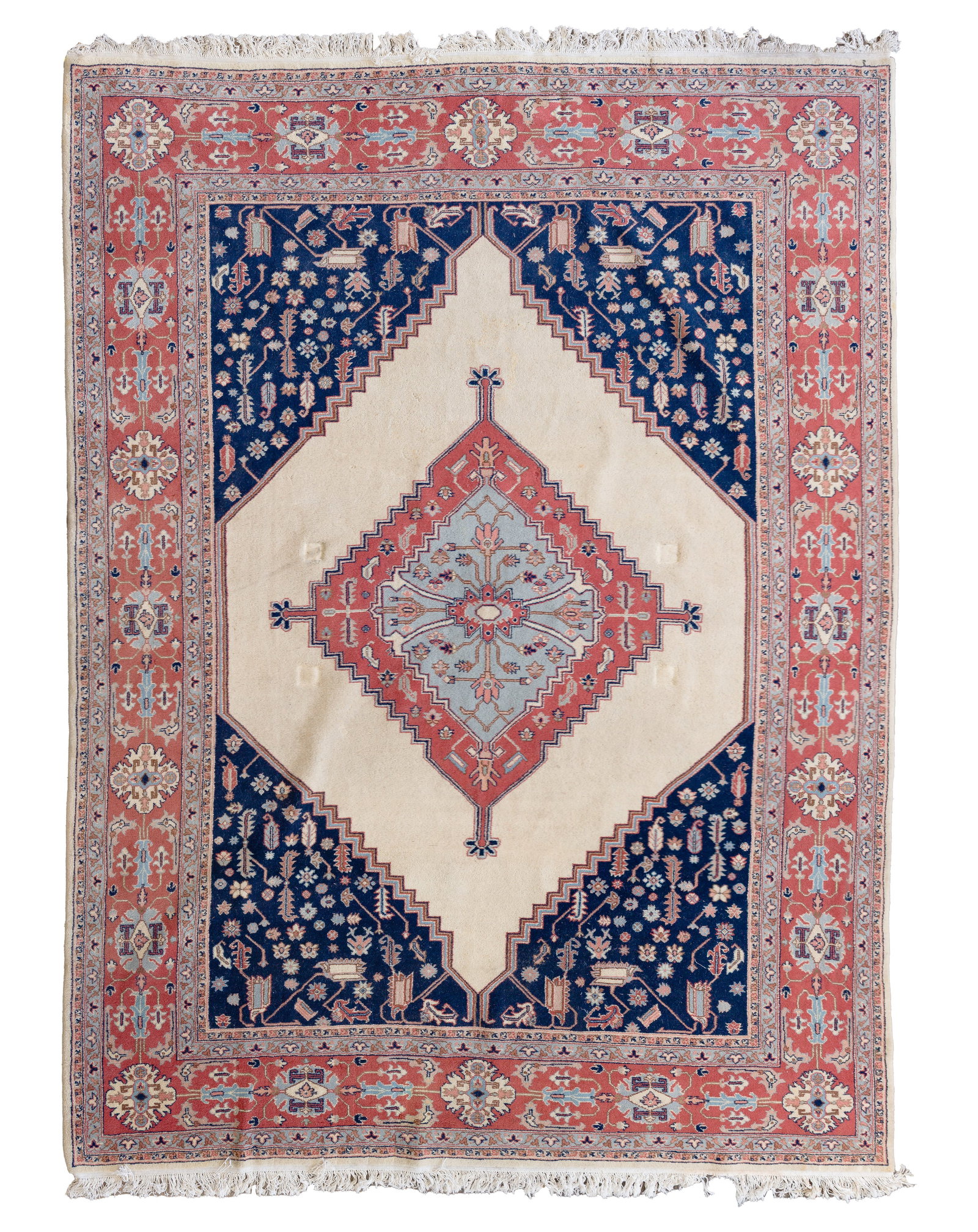 Persian Wool Rug: Persian Wool Rug Hand knotted in a geometric pattern, having center medallion, in hues of blue, red and brown on a cream field, retaining original Marshall Fields & Co. tags Property from: a Private