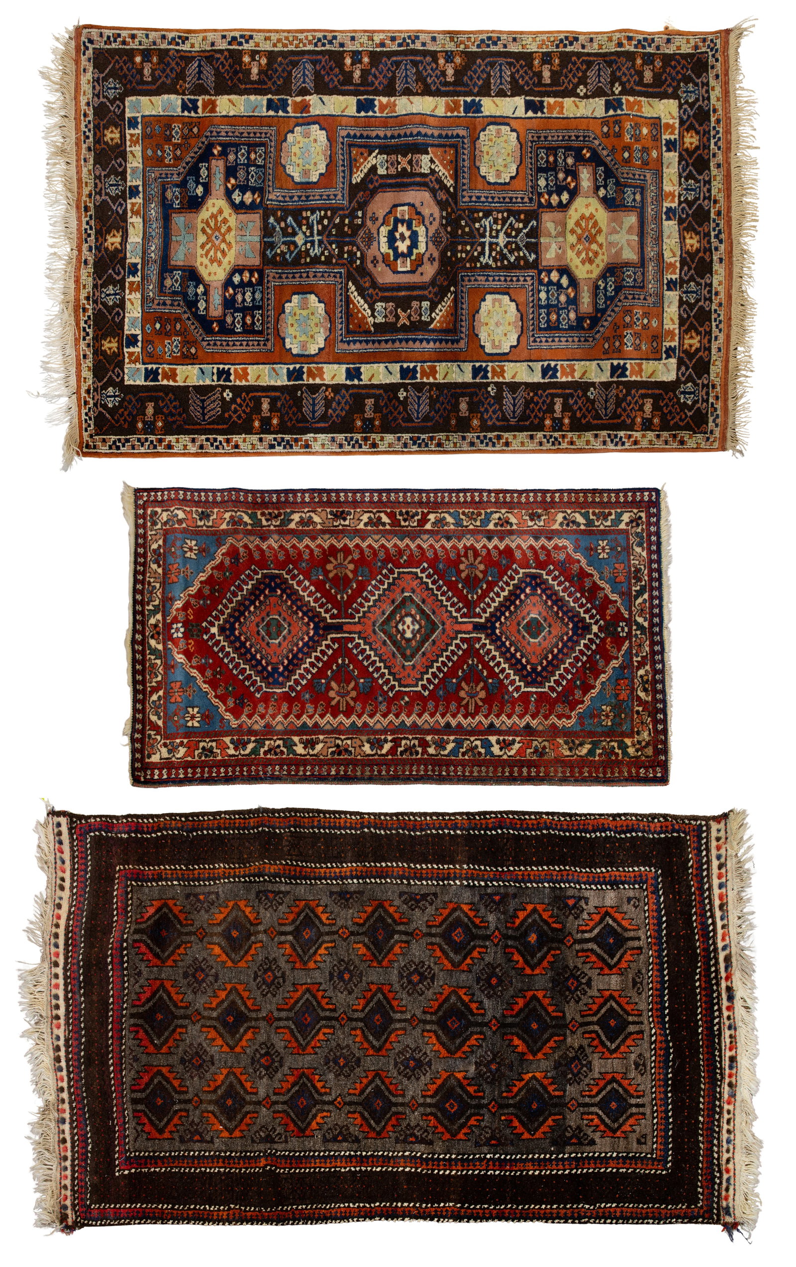 Persian Wool Rug Assortment: Persian Wool Rug Assortment (3) items including a geometric design in hues of cream, rust and green on a brown field, a geometric in hues of blue, salmon, cream and brown on red field (4 ft. 7 in. x