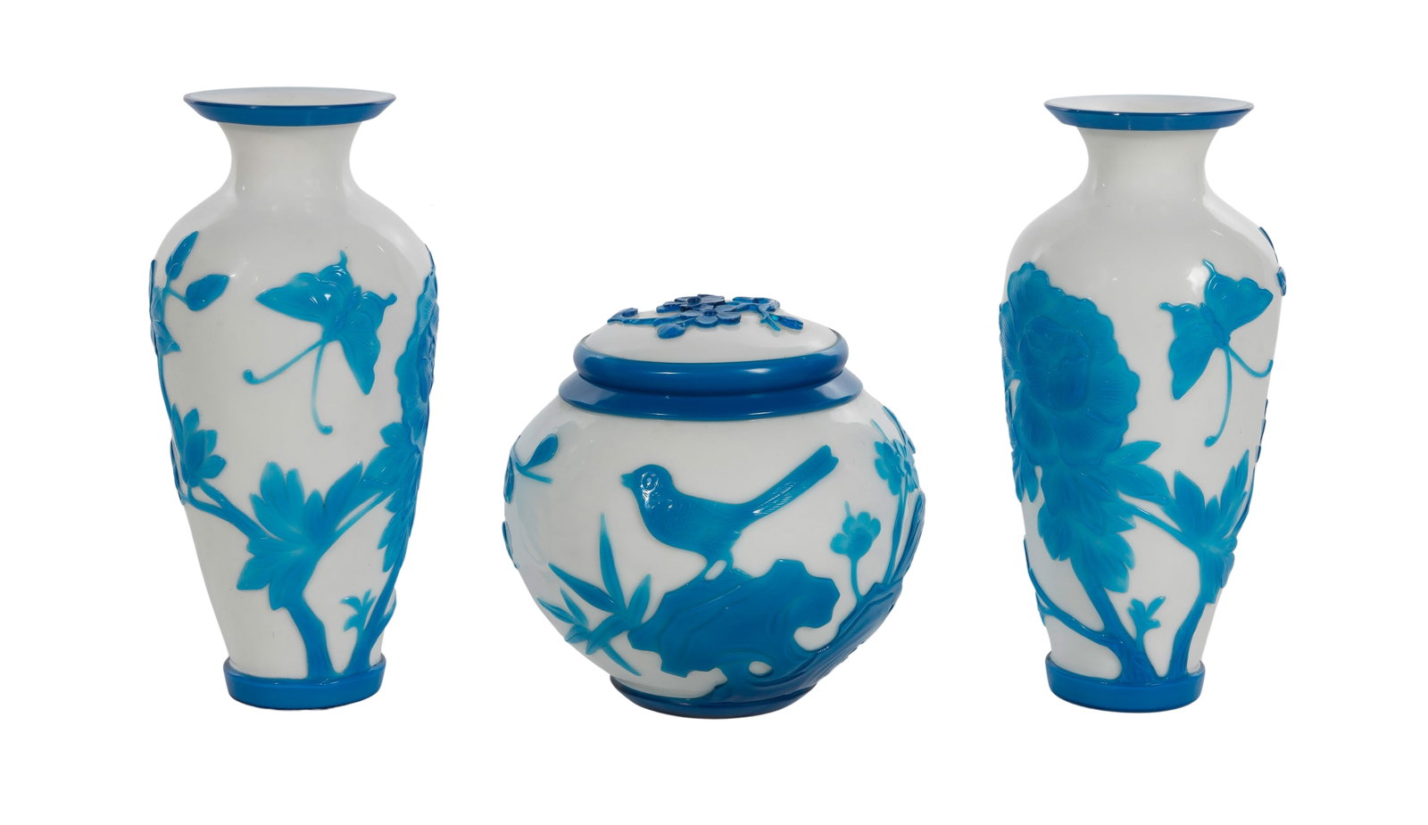Chinese Peking Glass Carved Overlay Assortment: Chinese Peking Glass Carved Overlay Assortment (3) items of blue on white cameo glass including a covered bowl having a bird amid prunus blossoms, and (2) vases, a mirror pair, having butterflies amid