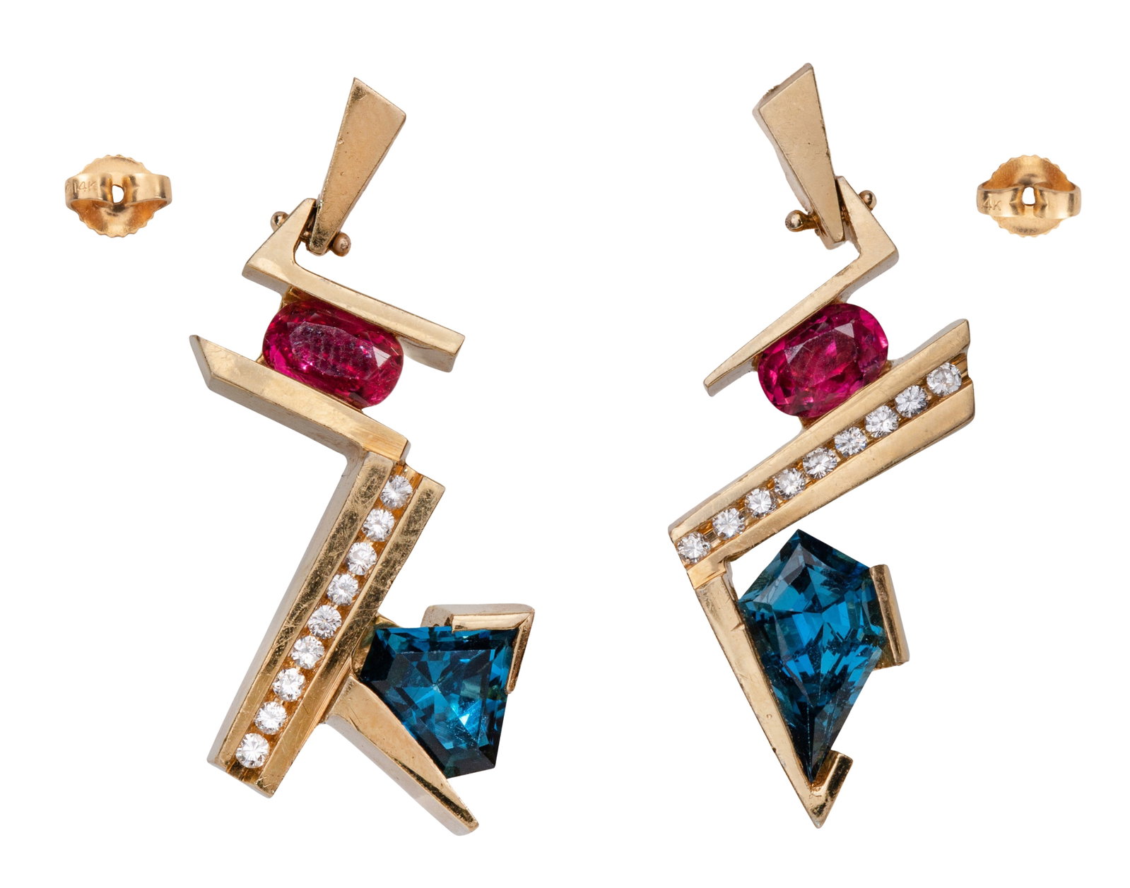 18k Yellow Gold, Ruby and Blue Topaz Earrings: 18k Yellow Gold, Ruby and Blue Topaz Earrings A pair of geometrical pierced earrings having an oval cut ruby and a triangular cut blue topaz separated by a row of round cut accent diamonds with backer