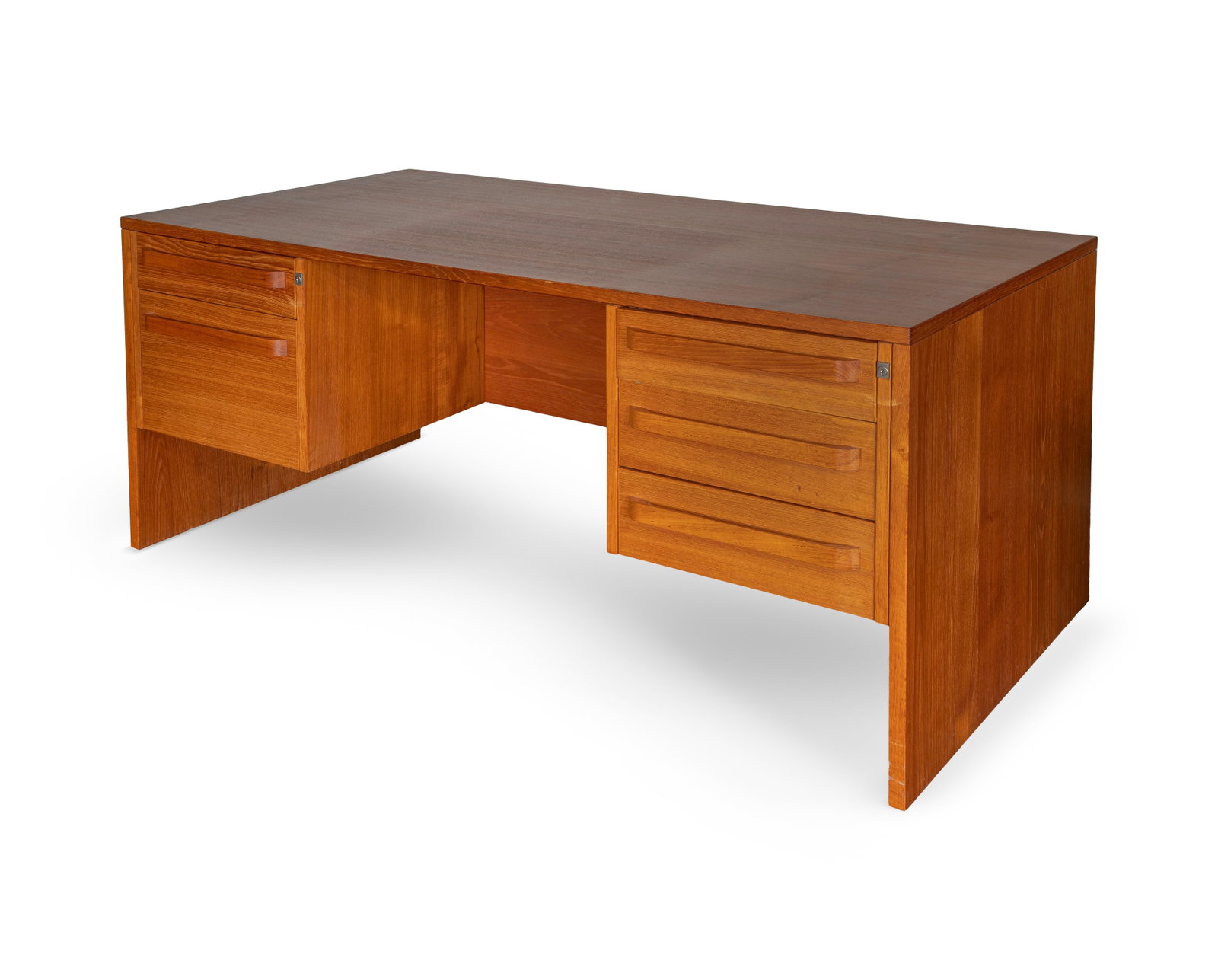 Modern Teak Desk: Modern Teak Desk An unmarked desk having three drawers to the right and a drawer over a deep file drawer to the left of knee-hole, both sides locking (four keys present) Property from: an Estate,