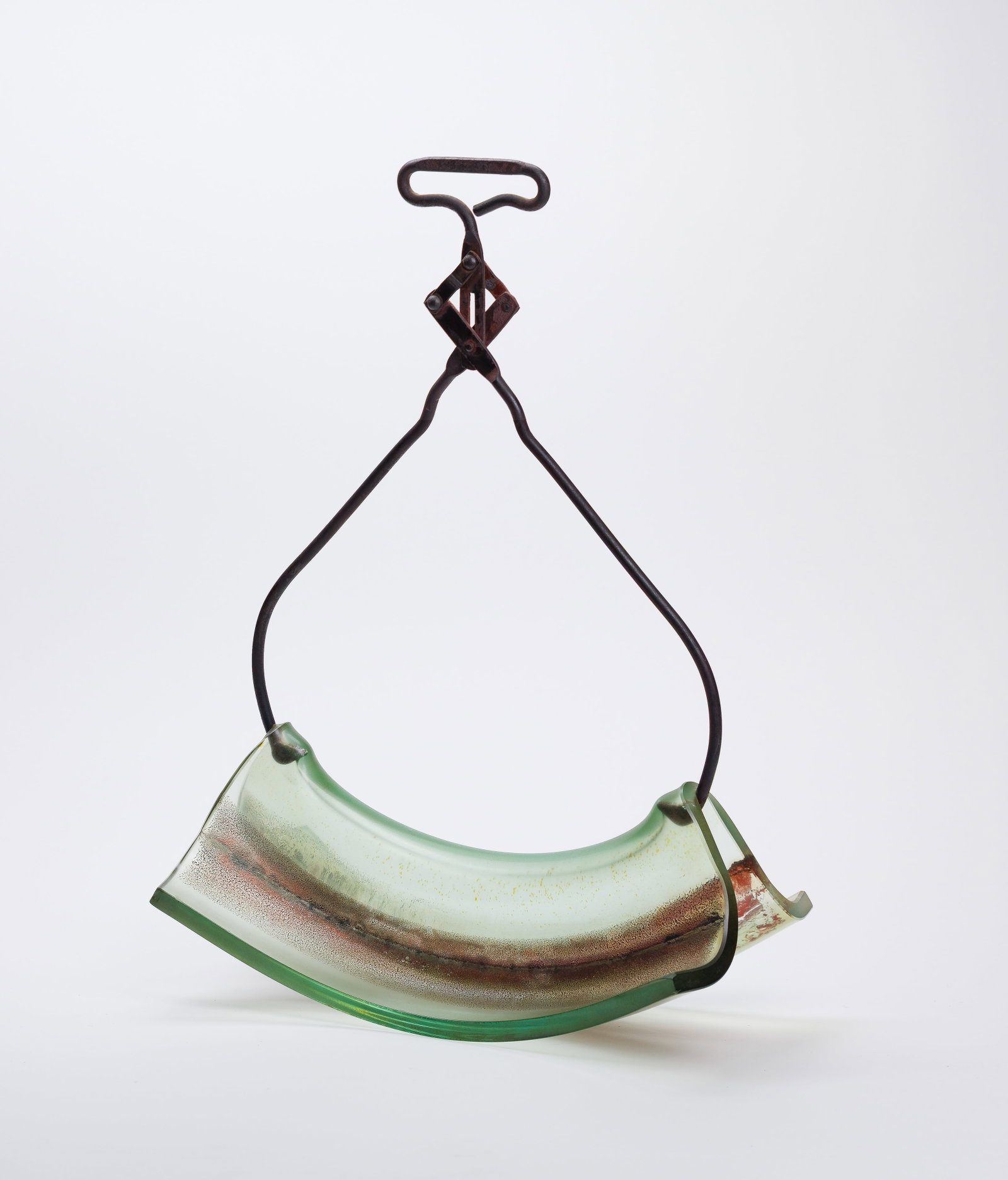 Attributed to Mary Shaffer (American, b.1947) Folded Glass on Tongs Sculpture: Attributed to Mary Shaffer (American, b.1947) Folded Glass on Tongs Sculpture Undated, unsigned, glass slab lifted and slumped into a curve on iron tongs Property from: an Estate, Chicago (Bucktown), 