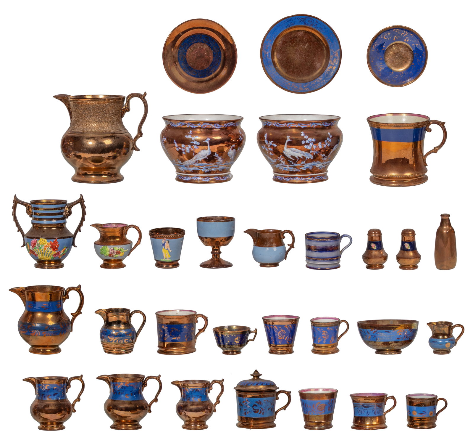 Copper Lusterware Assortment: Copper Lusterware Assortment (31) items of various shapes, sizes, styles and patterns including pitchers, cream jugs, mugs and saucers with metallic copper glazes and hand-painted blue or enamel accen
