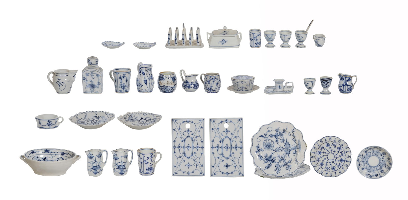 German Porcelain Assortment: German Porcelain Assortment (35) items including plates, bowls, small pitchers, cups, (2) cheese boards, a toast rack, a lidded canister, a lidded box, a candlestick and a pot having attached under pl