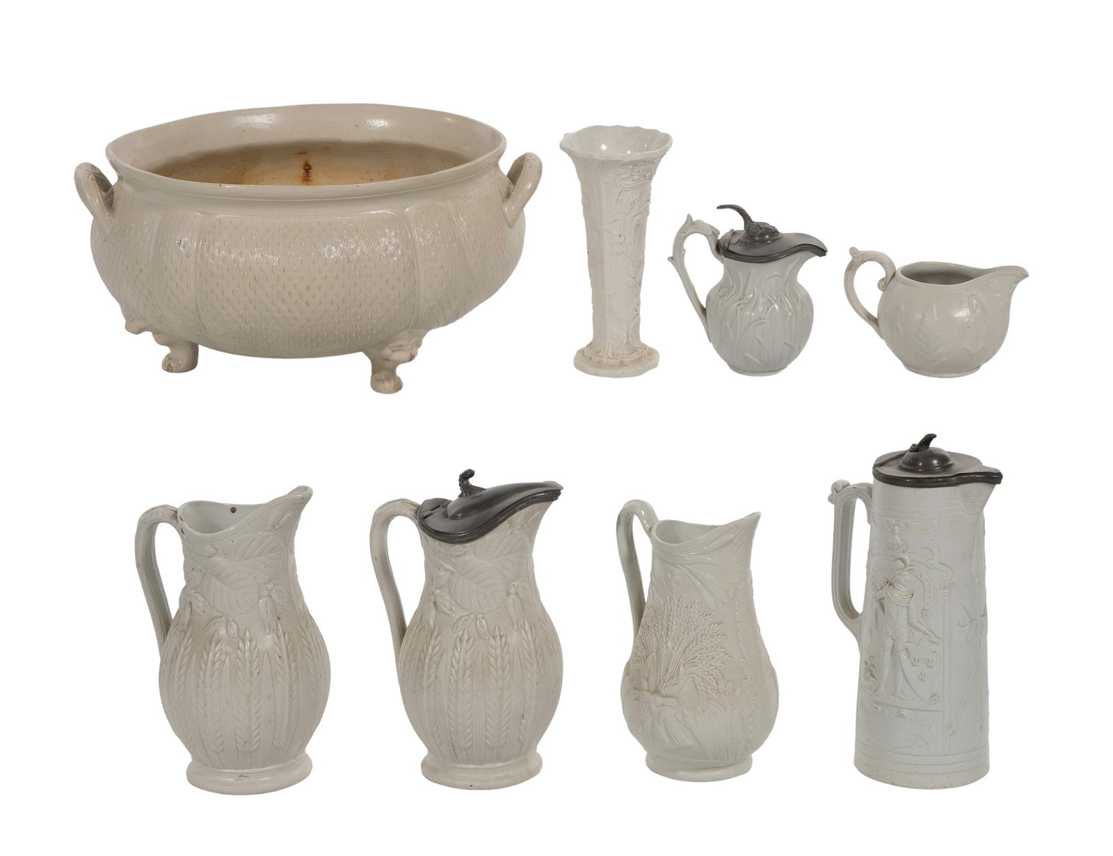 Salt Glaze Pottery Assortment: Salt Glaze Pottery Assortment (8) items, all pale salt-glazed stoneware including a footed bowl having loop form handles and a textured dot-and-rib relief pattern, pitchers having botanical and