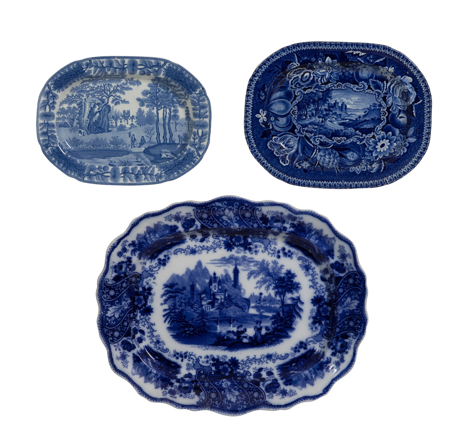 Ironstone Platter Assortment: Ironstone Platter Assortment (3) items including a flow blue ceramic platter having a scalloped rim, a scenic transferware design of a castle by a lake marked 'Burgess & Leigh' in the Nonpareil patter