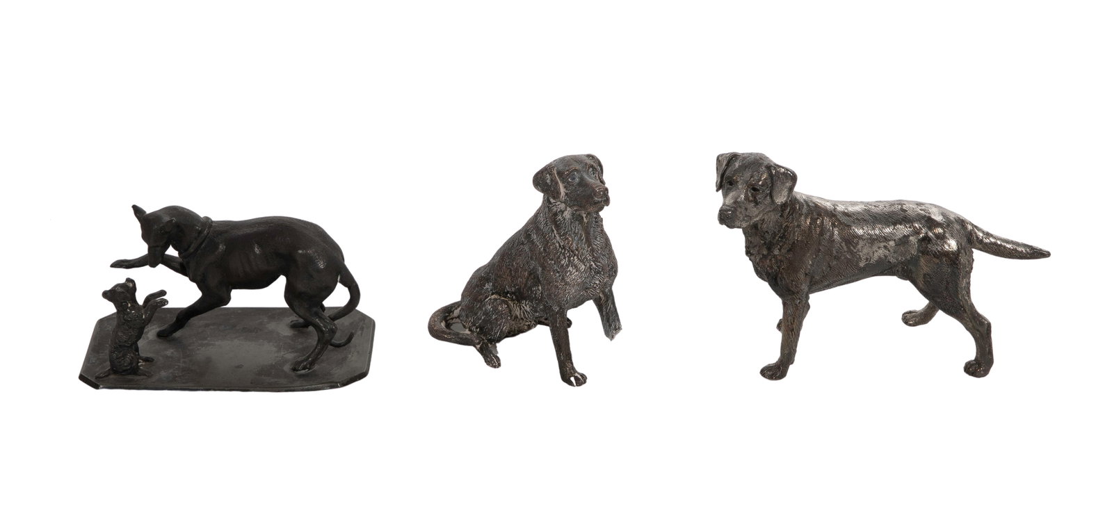 Silverplate Dog Figurines: Silverplate Dog Figurines (3) items including a dog and puppy on a rectangular base marked 'Aurora 378', a seated dog and a standing dog Property from: a Private Collector, Wheaton, Illinois Height: