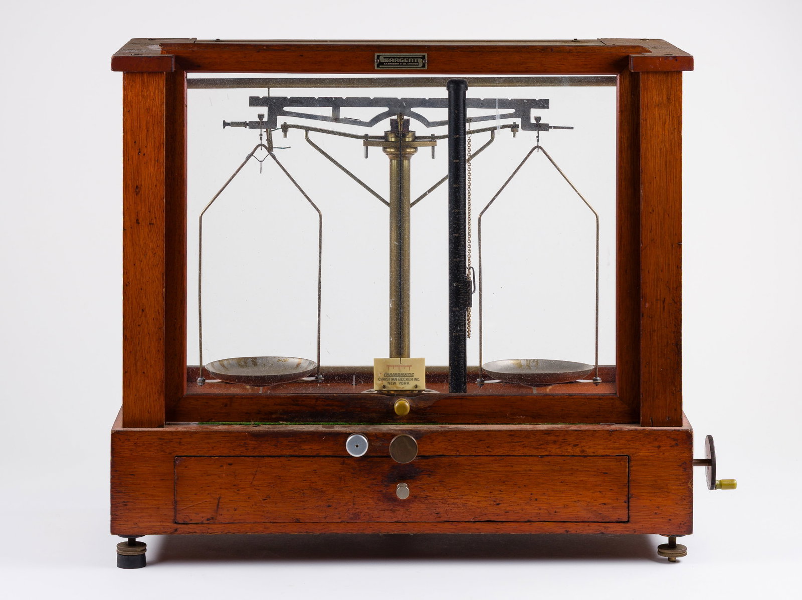 E. H. Sargent Co. Chainomatic Balance Scale: E. H. Sargent Co. Chainomatic Balance Scale Wood and glass case having weights and accessories Property from: an Estate, Antioch, Illinois Height: 17 1/2 inches, Width: 20 1/2 inches, Depth: 9 1/2