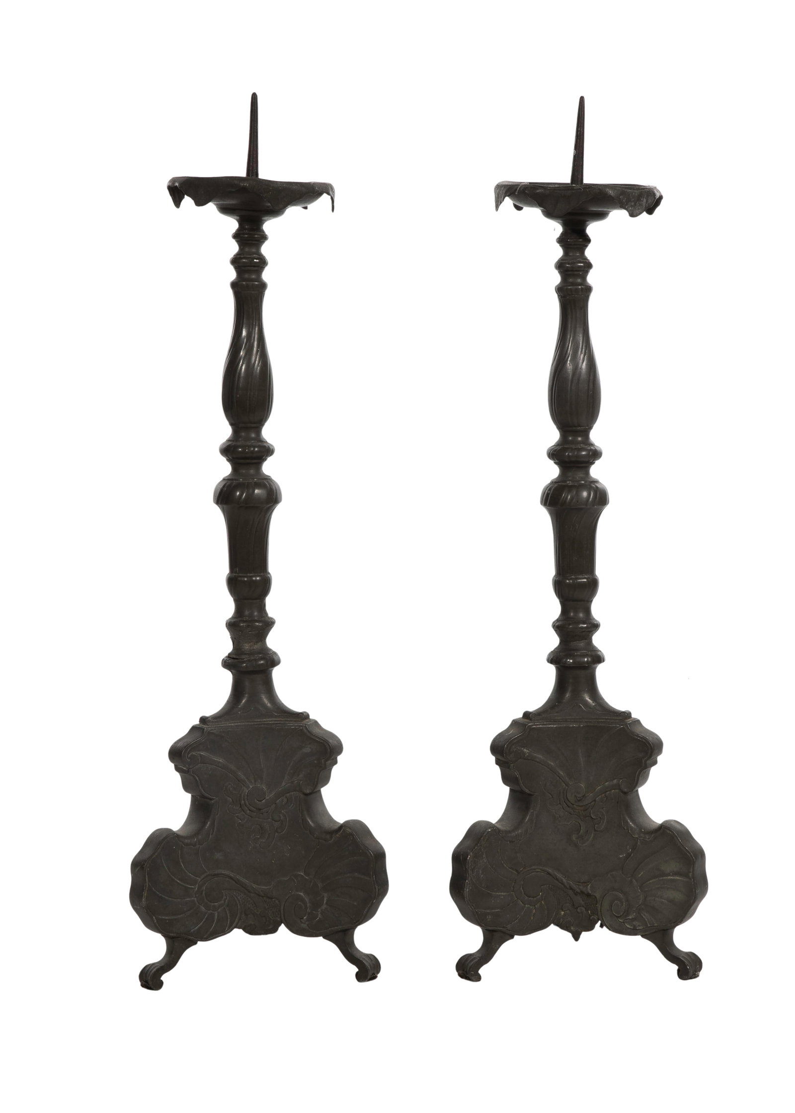 Bohemian Metal Altar Prickettes: Bohemian Metal Altar Prickettes A pair on tripod feet, 3-sided bases having low relief foliate motif, supporting baluster standards, ruffled drip pans and 3.125-inch spikes Property from: a Private