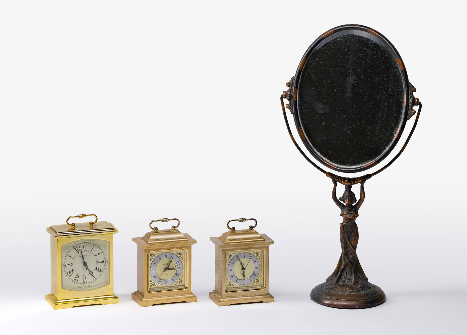 Brass Carriage Clock Assortment: Brass Carriage Clock Assortment (4) total items including (2) Seth Thomas and (1) Howard Miller; together with an Art Nouveau style mirror Property from: a Private Collector, Wheaton, Illinois