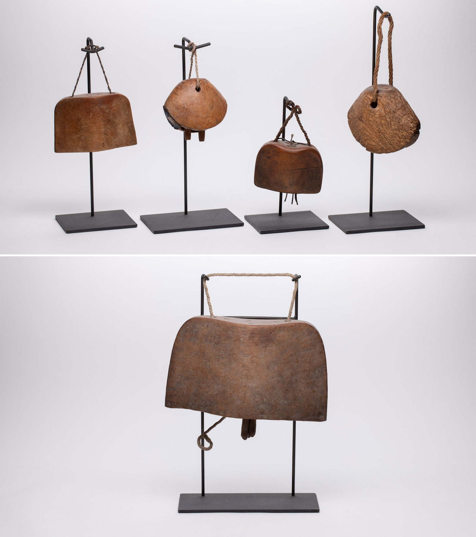 Ethnographic Carved Wood Cow Bell Assortment: Ethnographic Carved Wood Cow Bell Assortment (5) items including (1) likely from India and (4) East African, all having fiber suspension cords and metal display stands Property from: an Estate,