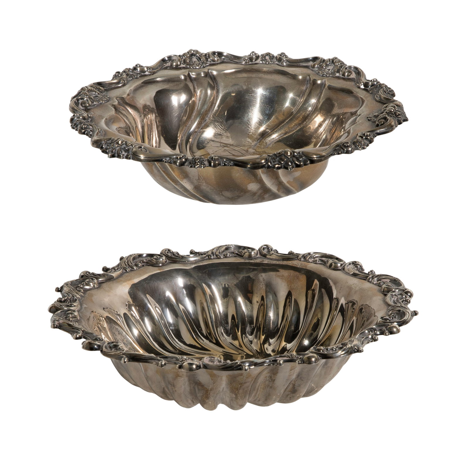 Sterling Silver Bowls: Sterling Silver Bowls (2) items including a fluted bowl having a scroll and bead rim hallmarked Wallace and a floral and scroll bowl hallmarked Meriden (both marked 'sterling') Property from: a