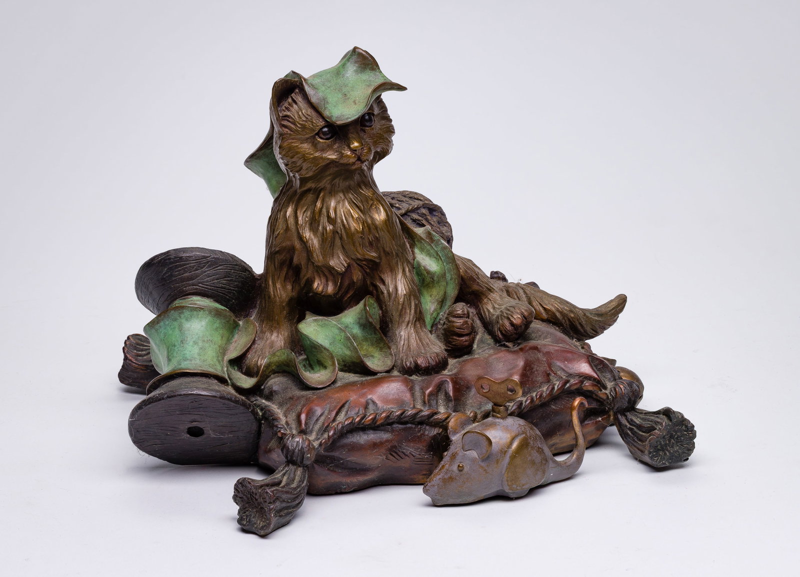 E. C. Wynne (American, 20th Century) 'Spoiled Rotten' Bronze and Copper Sculpture: E. C. Wynne (American, 20th Century) 'Spoiled Rotten' Bronze and Copper Sculpture Undated, cast signed, titled, #30/50, a whimsical sculpture depicting a cat resting on a tasseled pillow with a toy mo