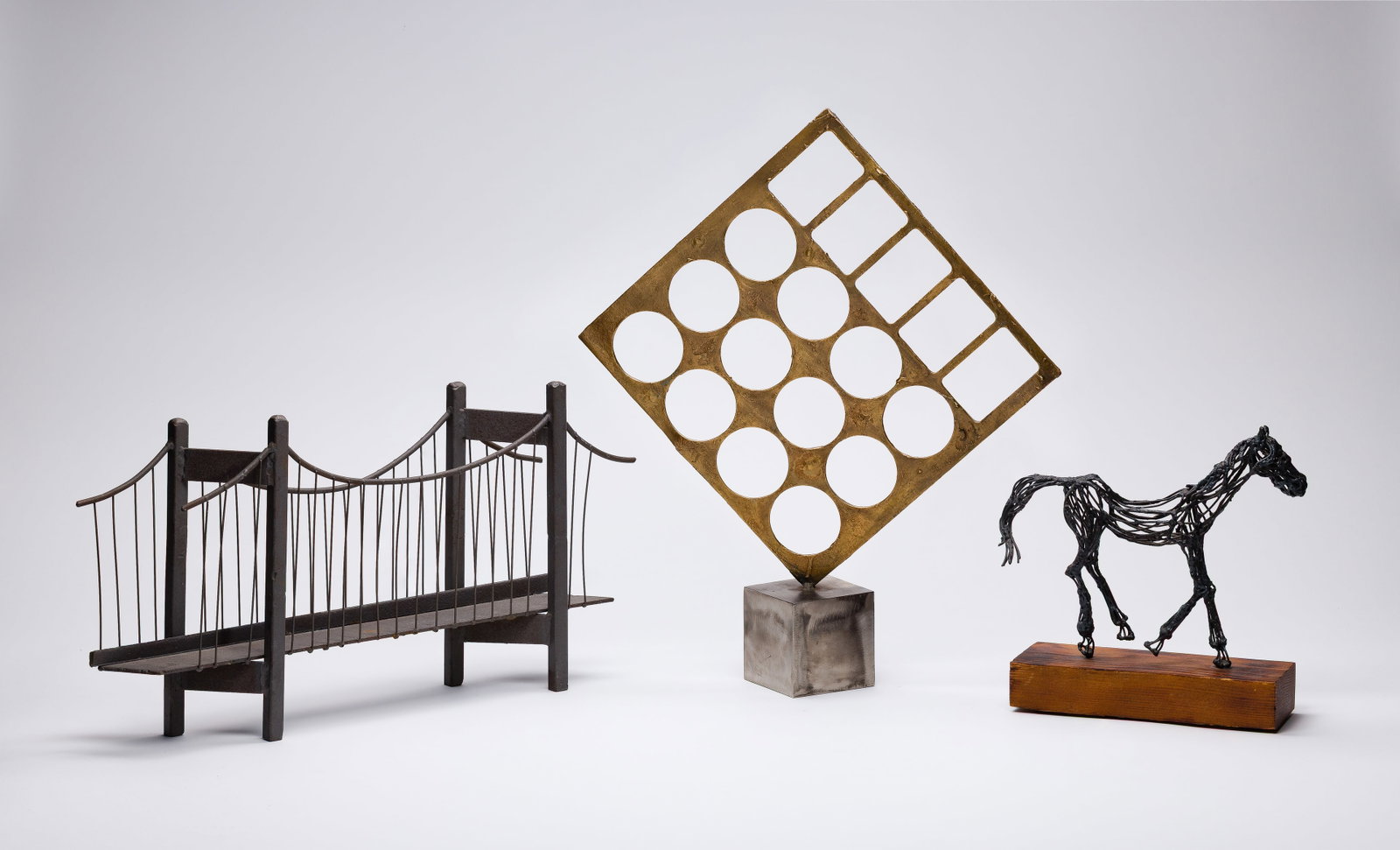 Brutalist Metal Sculpture Assortment: Brutalist Metal Sculpture Assortment (3) items including an abstract bronze-tone square sheet having punched-out circles and rectangles mounted to a brushed steel cube base having cast signature 'E. B
