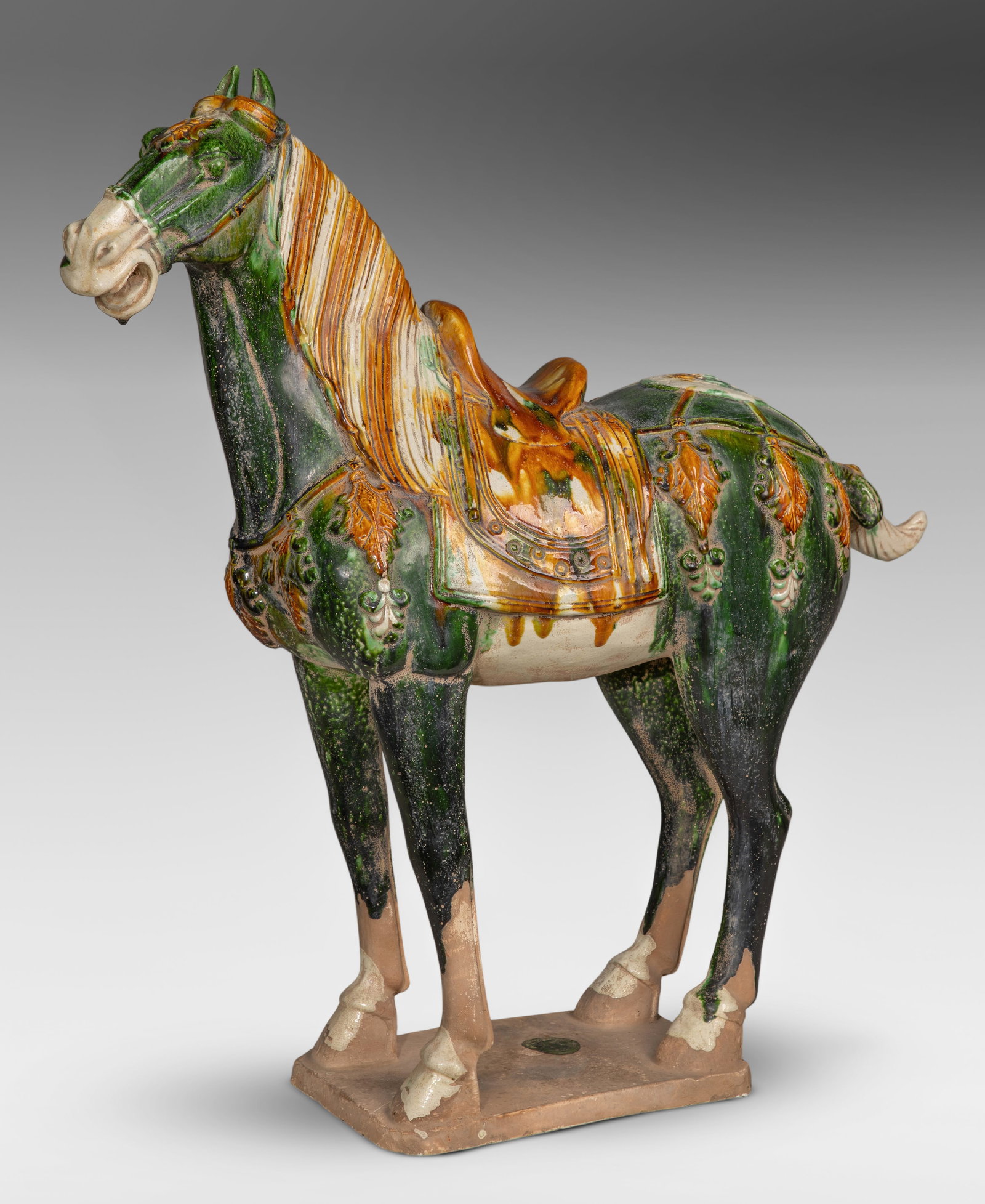 Chinese Tang Style Sancai Ceramic Horse: Chinese Tang Style Sancai Ceramic Horse Large scale horse sculpture having a three-color sancai glaze, standing on an unglazed base Property from: a Private Collector, Glen Ellyn, Illinois Height: 26 
