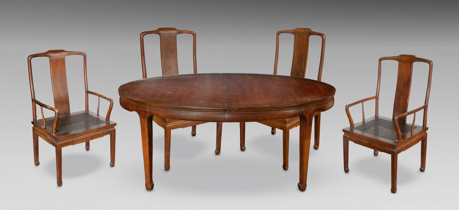 Walnut Dining Suite: Walnut Dining Suite (9) items including an oval dining table, (2) armchairs and (6) side chairs having square woven cane seats and splat backs, all having Chinese style straight legs and inward curvin