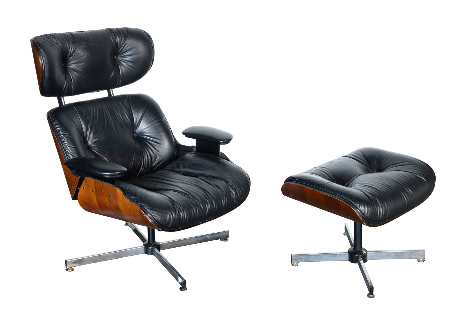 Eames Style Chair and Ottoman: Eames Style Chair and Ottoman Eames style molded walnut plywood frames having button-tufted black leather upholstery, stainless steel bases Property from: an Estate, Deerfield, Illinois Height: 40 inc