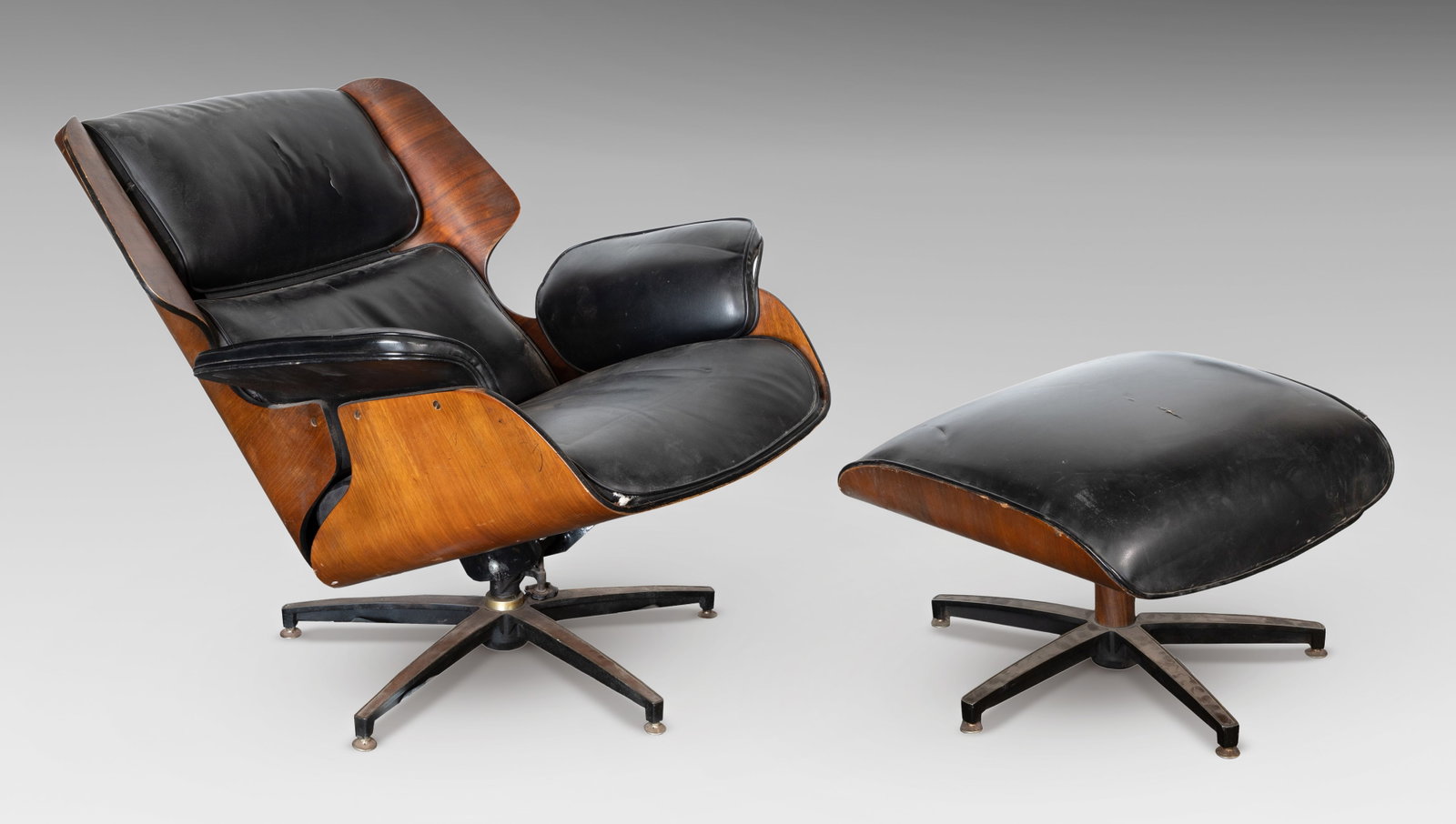 Drexel Lounge Chair and Ottoman: Drexel Lounge Chair and Ottoman Bent walnut plywood frames, having bonded leather upholstery, retaining Drexel label underside of ottoman Provenance: From the collection of Mary Kay O’Brien
