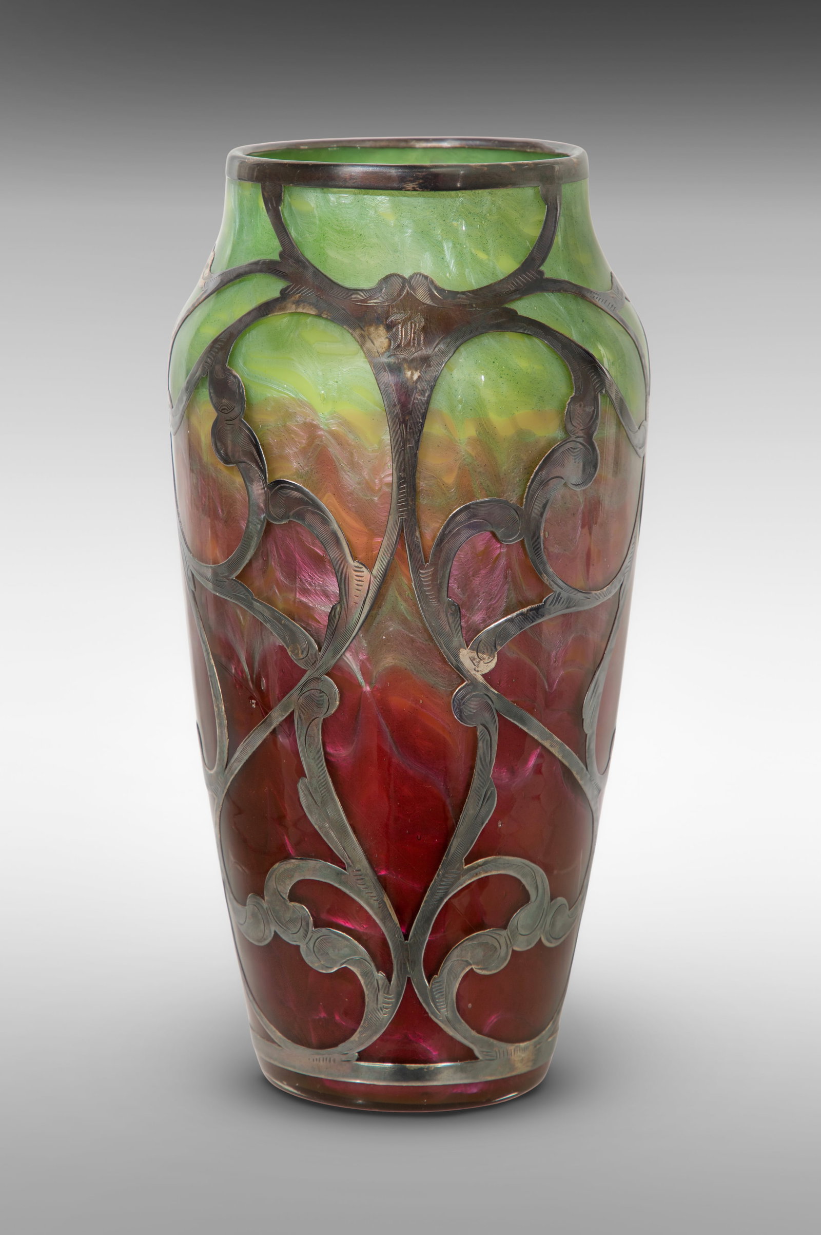 Loetz Titania Silver Overlay Vase: Loetz Titania Silver Overlay Vase Iridescent gradient glass moving from green to purple, a pierced and chased vine and leaf pattern overlay (marked 'sterling') having a central cartouche Property