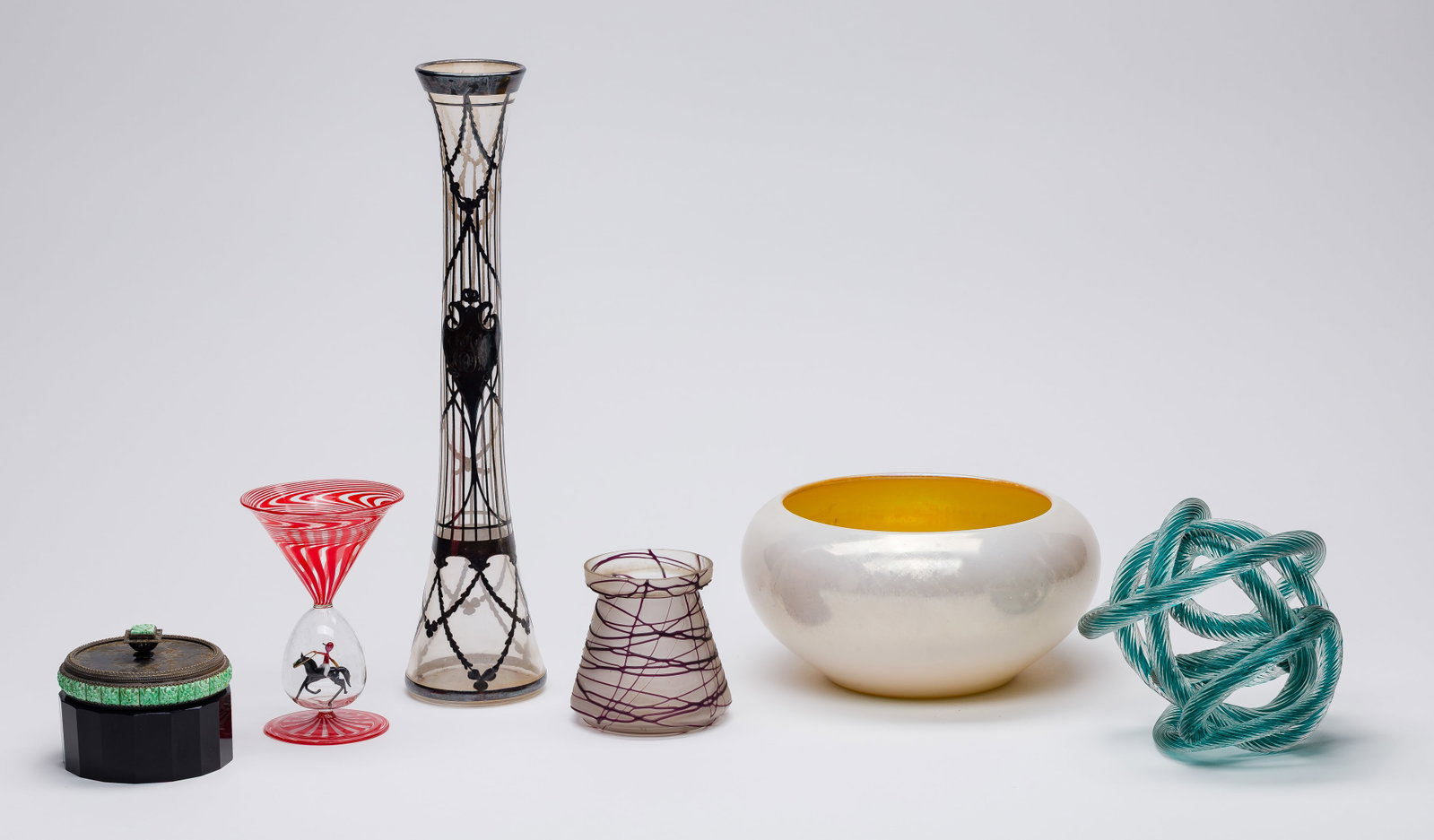 Art Glass Assortment: Art Glass Assortment (6) items including a 1930s Bimini Werkstatte stemmed glass having red swirl and bubble stem containing lamp-work horse and rider, a Steuben gold aurene on calcite bowl and