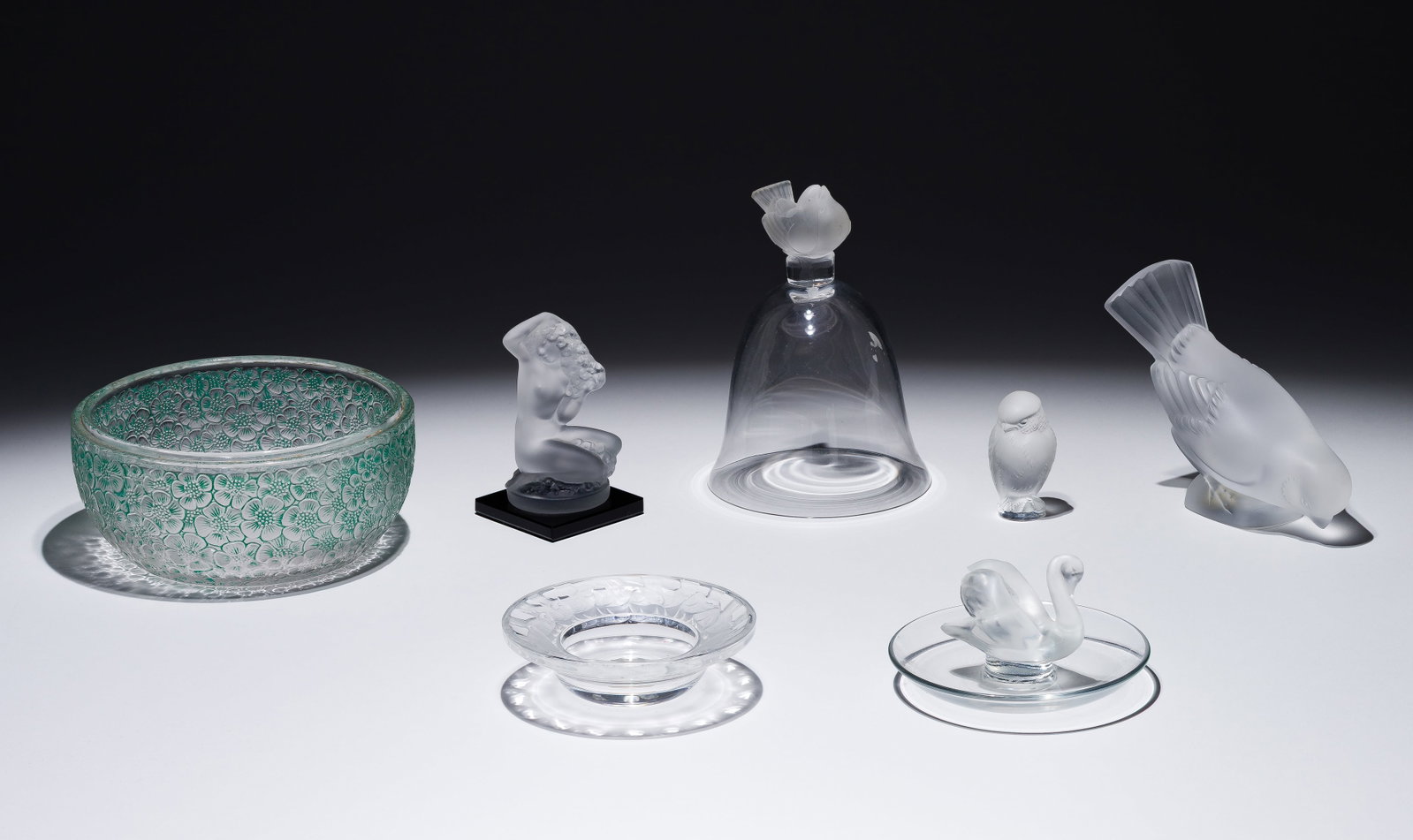 Lalique Crystal Assortment: Lalique Crystal Assortment (7) items including a 1926 Rene Lalique Eglantines box (lacking lid) having green tint and etched mark underside, a Floreal figurine, a Moineau figurine, a Rapace figurine,