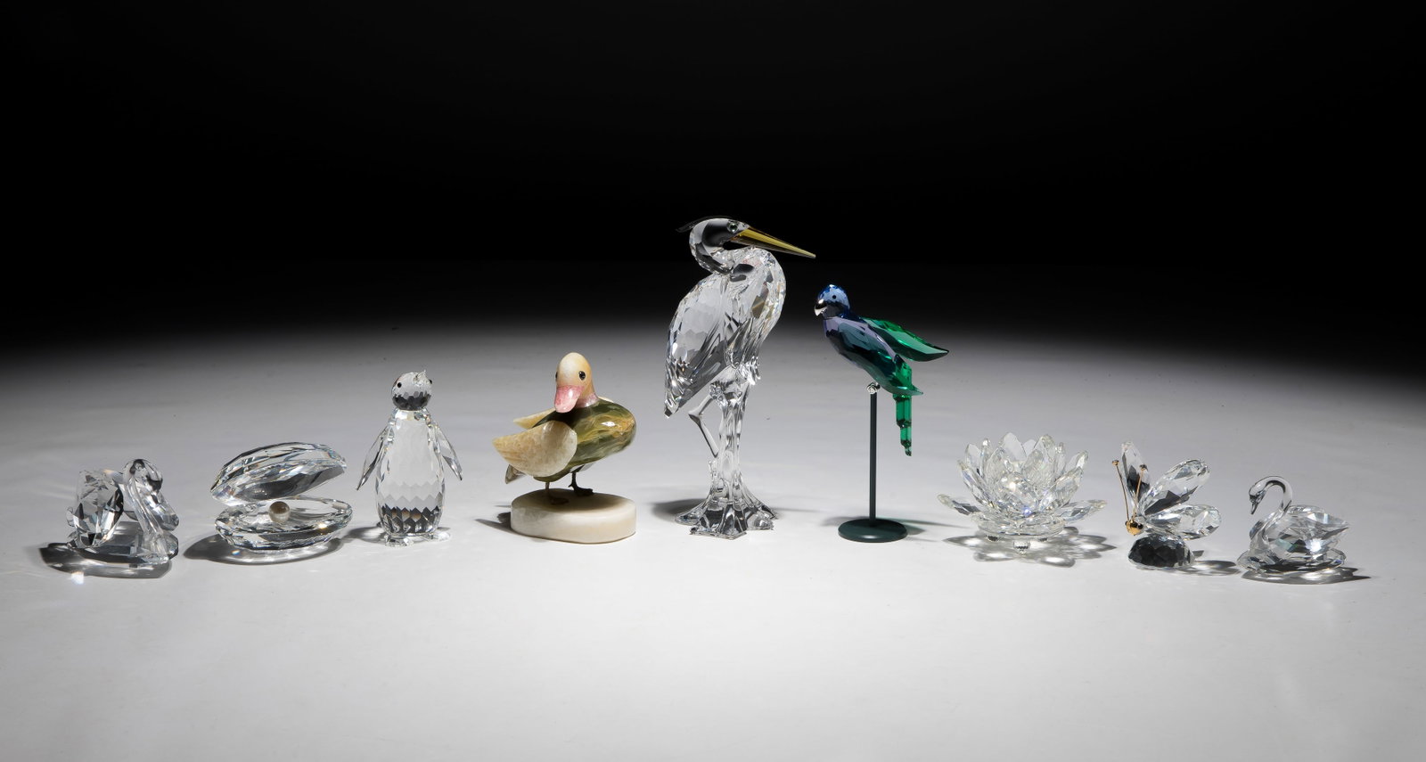 Swarovski Crystal Figurine Assortment: Swarovski Crystal Figurine Assortment (9) total items including a Silver Heron, a green Kingfisher / Paradise Bird as well as miniature animals, a shell having a pearl, a lotus flower, swans, a