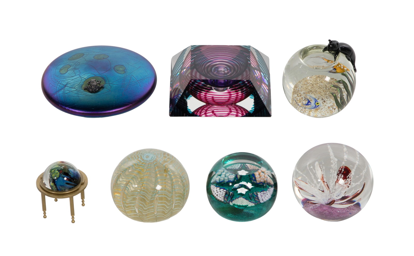 Art Glass Paperweight Assortment: Art Glass Paperweight Assortment (7) items including an iridescent blue lily pad having an applied textured center and a silver frog accent signed by John Ditchfield for Glasform, a multi-colored