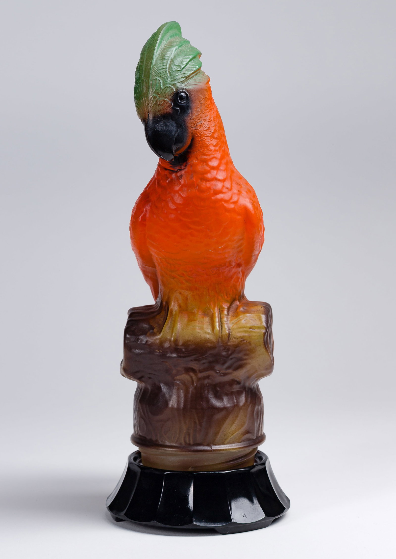 Tiffin Glass Parrot Table Lamp: Tiffin Glass Parrot Table Lamp Partial novelty electric lamp having a molded multi-color matte glass shade and an opaque black glass base Property from: an Estate, Glen Ellyn, Illinois Height: 13 1/4