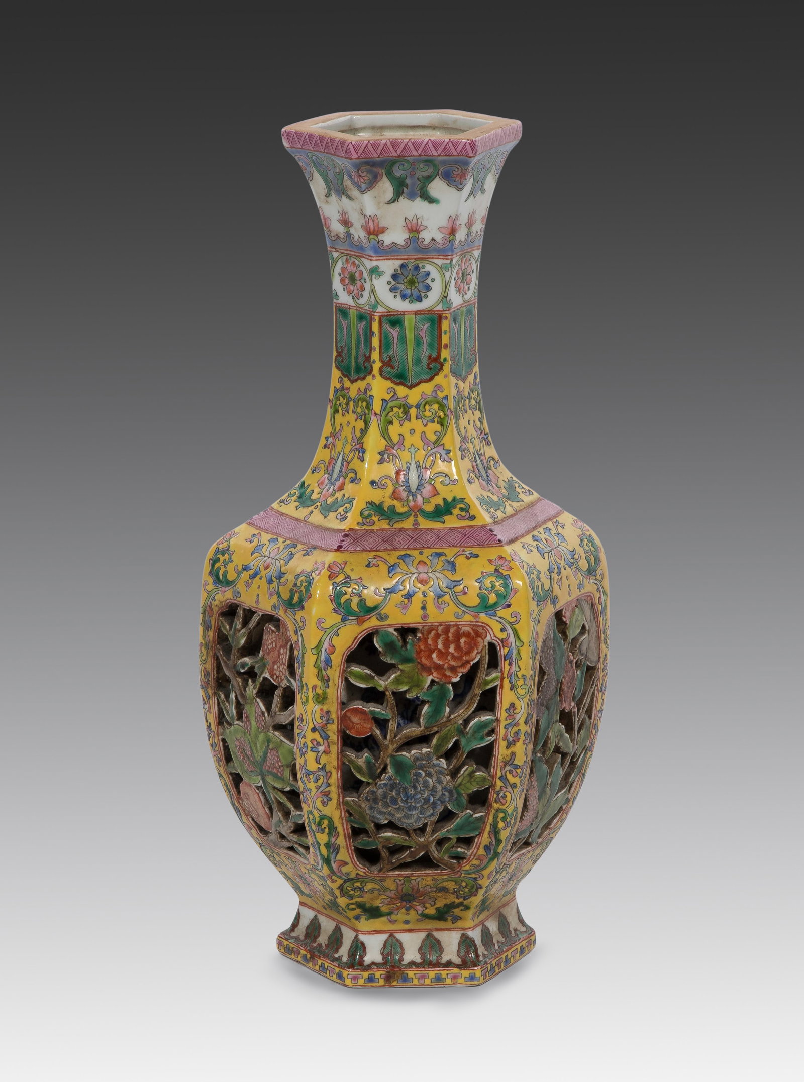 Chinese Reticulated Porcelain Vase: Chinese Reticulated Porcelain Vase A famille rose on yellow ground decorated hexagonal vase having double-walled construction, the outer wall having pierced floral panels, black enamel 4-character Qia