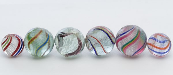 Latticino Swirl Marbles: Latticino Swirl Marbles Six marbles with white interior swirls and multi-colored exterior swirls Diameter: 1.09 inches (largest) Category: Collectibles > Marbles Shipping Status: Leonard Auction, Inc.