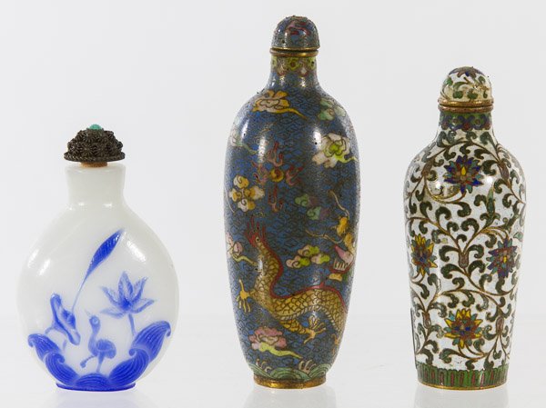 Asian Snuff Bottles: Asian Snuff Bottles Three items including a milk glass bottle with raised blue flower and metal floral cap, a dragon cloisonne bottle with top stick and a floral cloisonne bottle with top stick; Prove